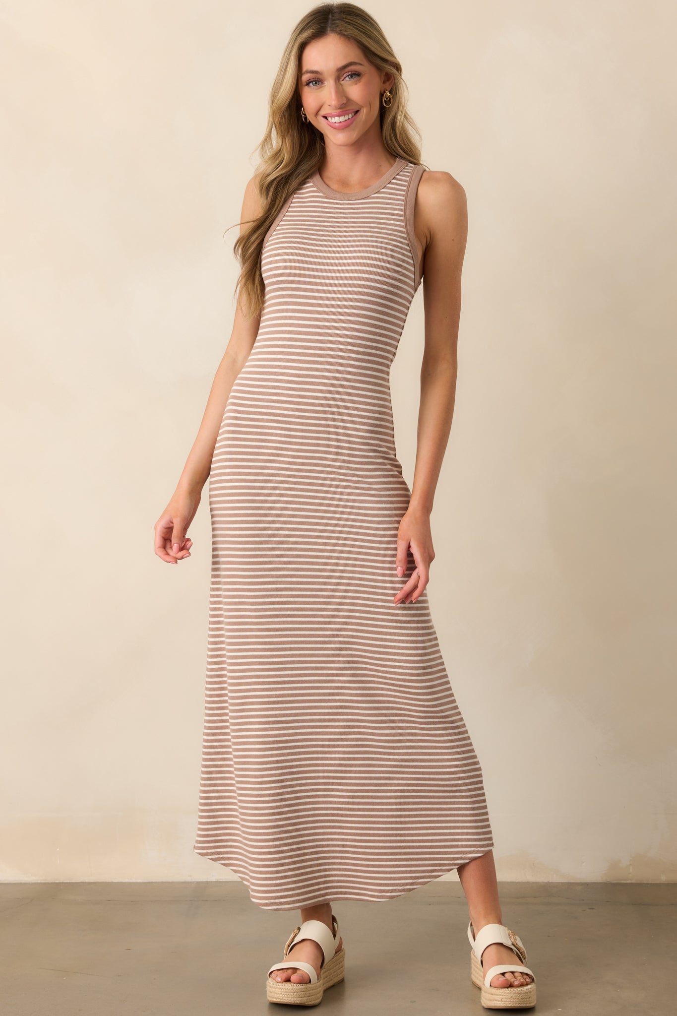 Bodycon tan iced coffee midi dress with a sleeveless design, ribbed fabric, and a smooth, scoop bottom hem.