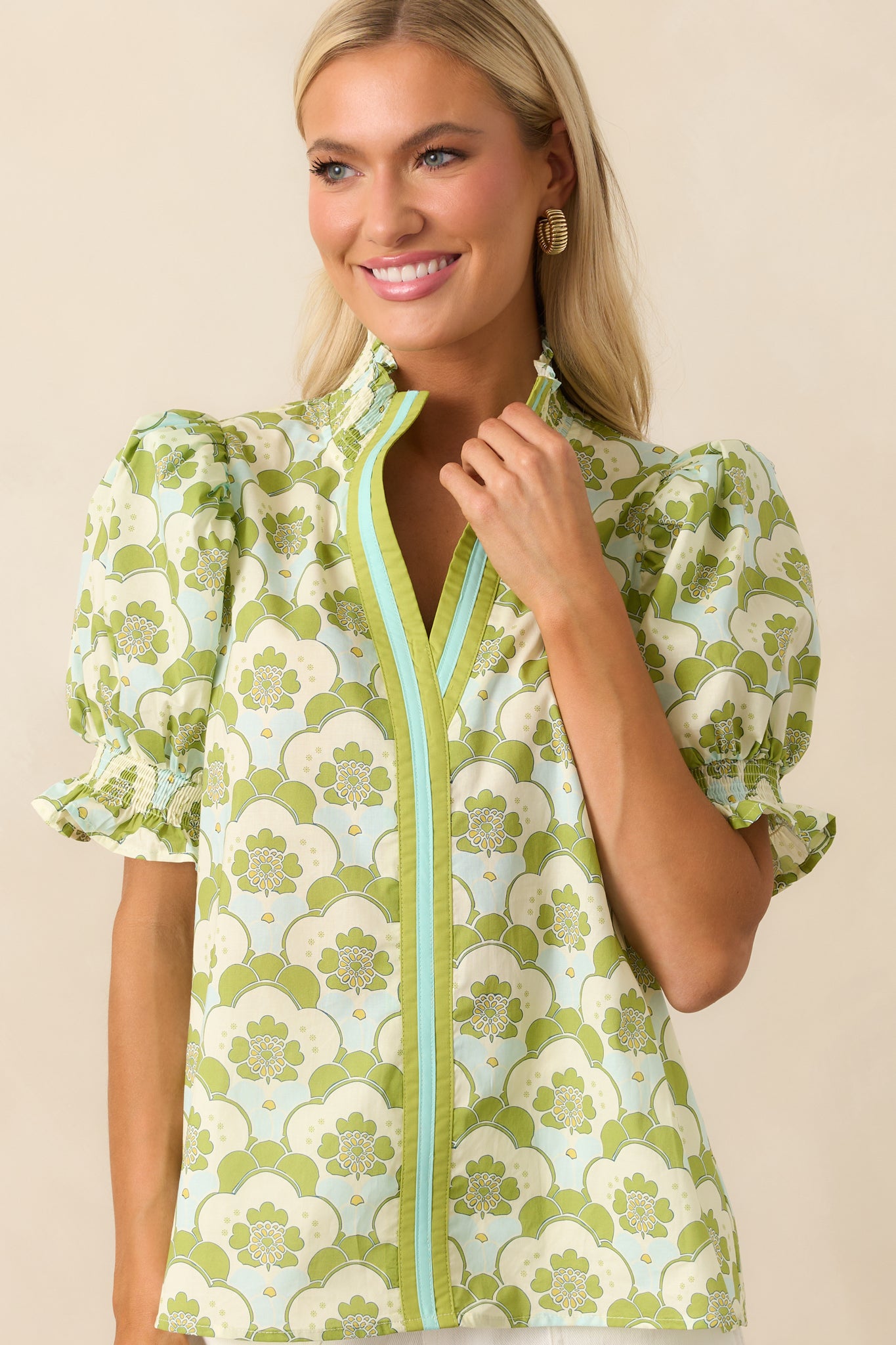 Focused view of the upper chest area of the top, emphasizing the abstract floral print and gathered neckline.