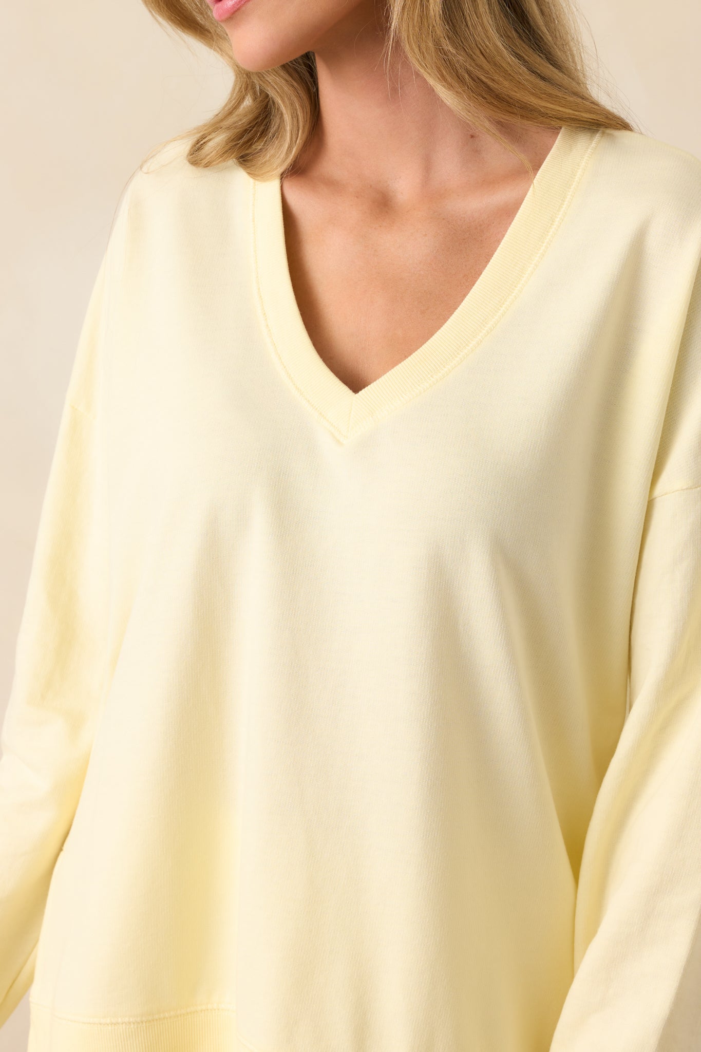 Textured mellow yellow sweatshirt with ribbed hems, a deep v-neckline, and oversized fit in a soft cotton blend.