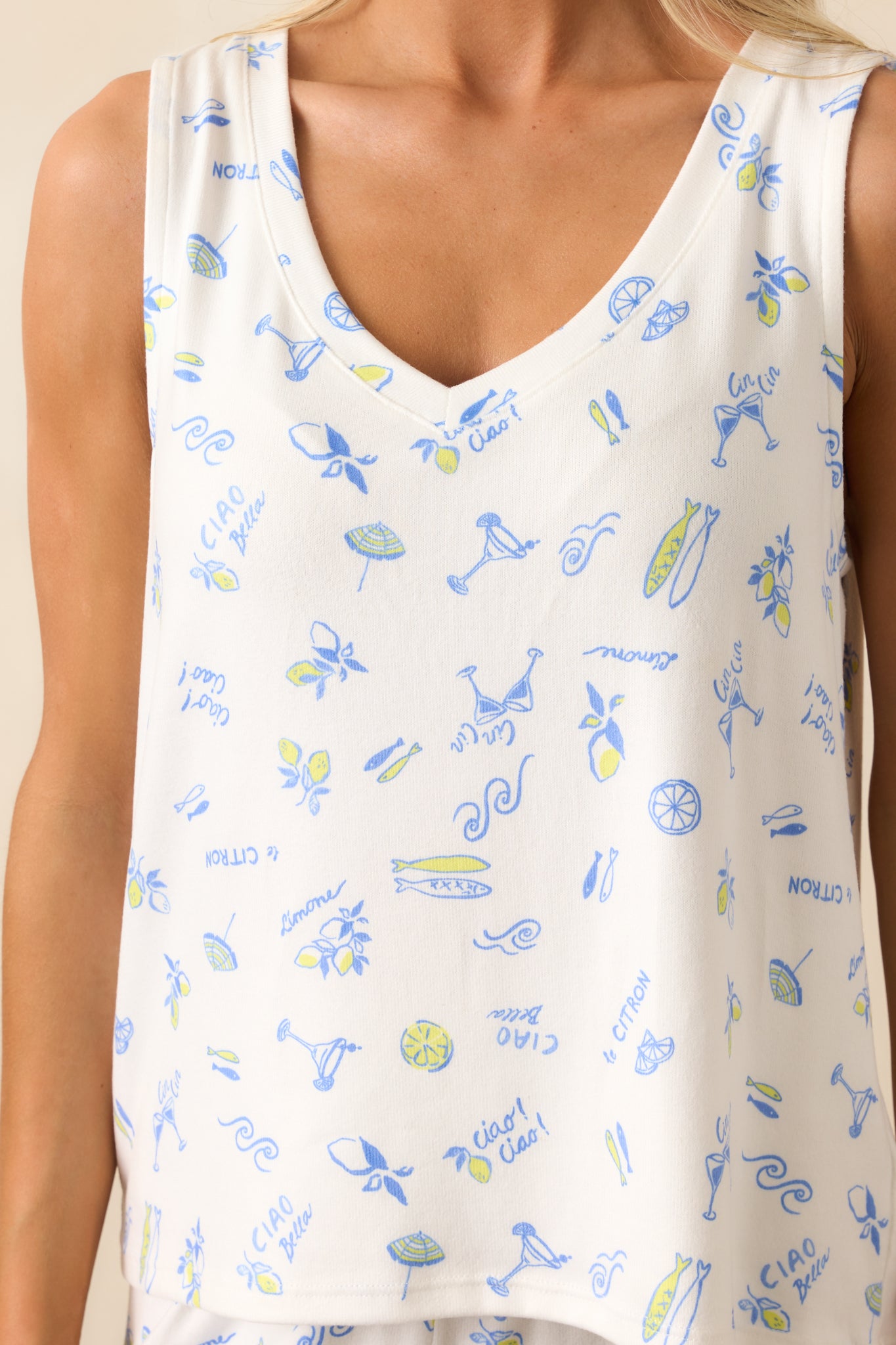 Close-up of silky jersey fabric showing the intricate blue and yellow Italian-inspired print and v-neck stitching.