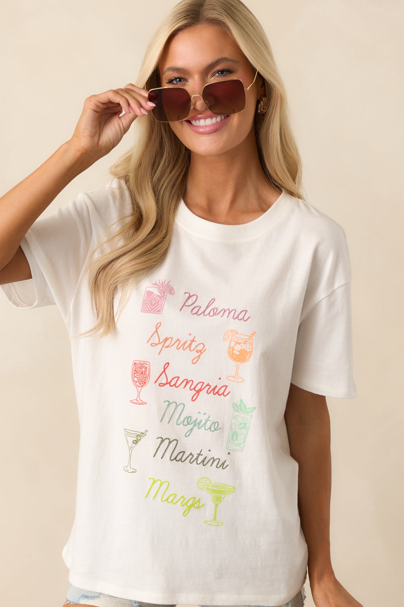 Cropped shot displaying the tee’s upper section with visible cocktail embroidery and screen print detail.