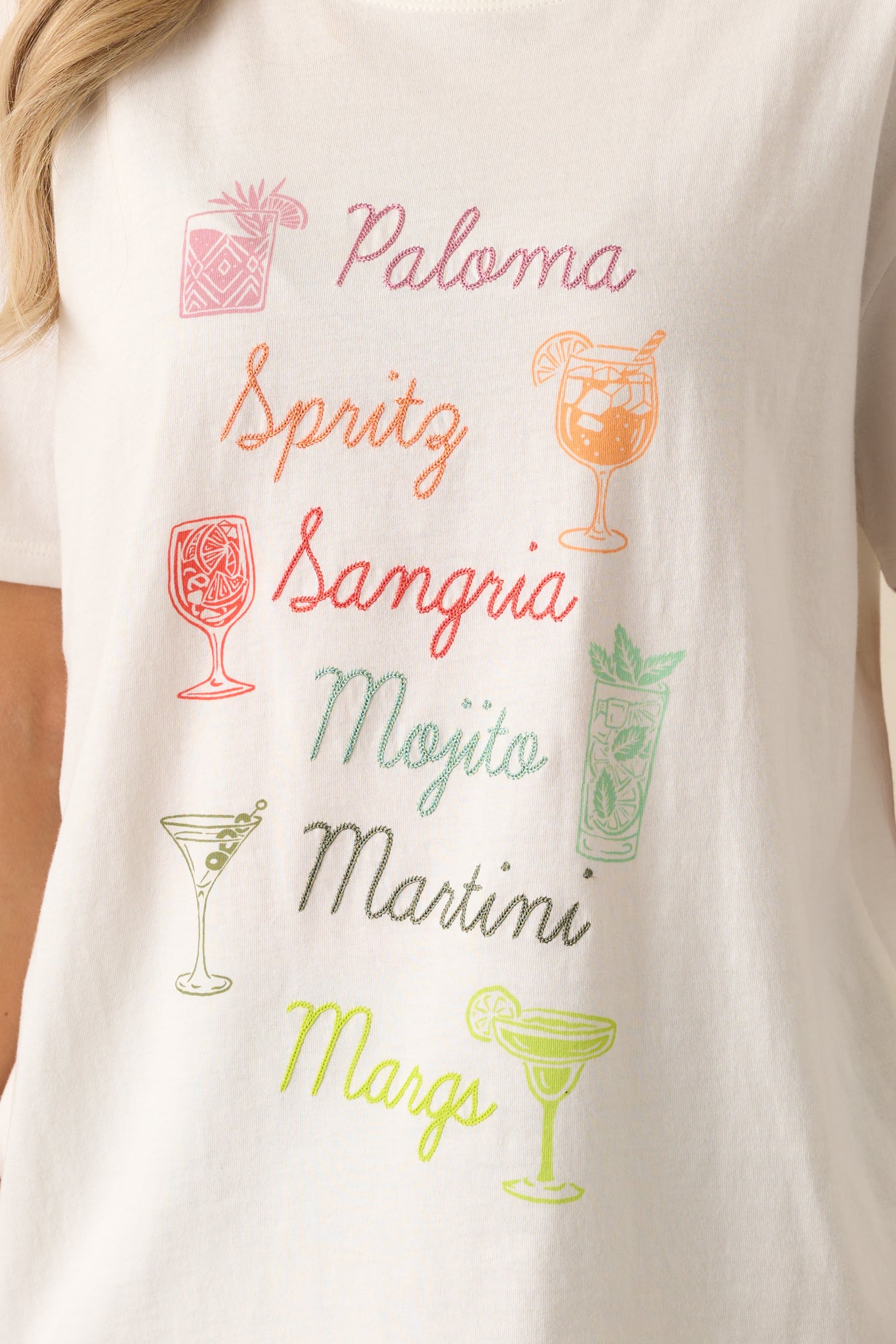 Close-up of the tee’s embroidered cocktail names and colorful printed drinks, highlighting texture and print clarity.