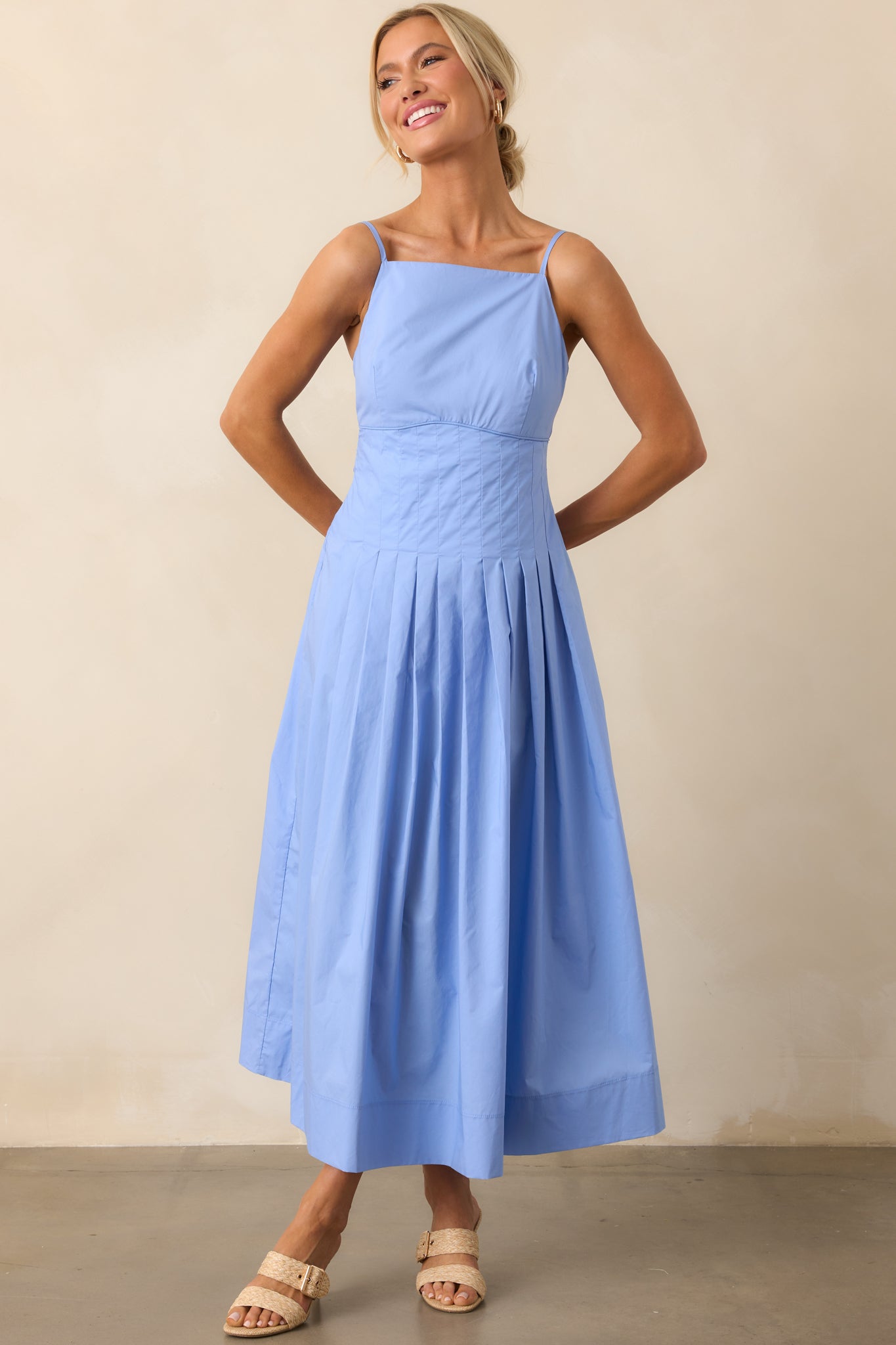 Complete front view of the midi dress with square neckline, piping detail, and gently flared pleated skirt.