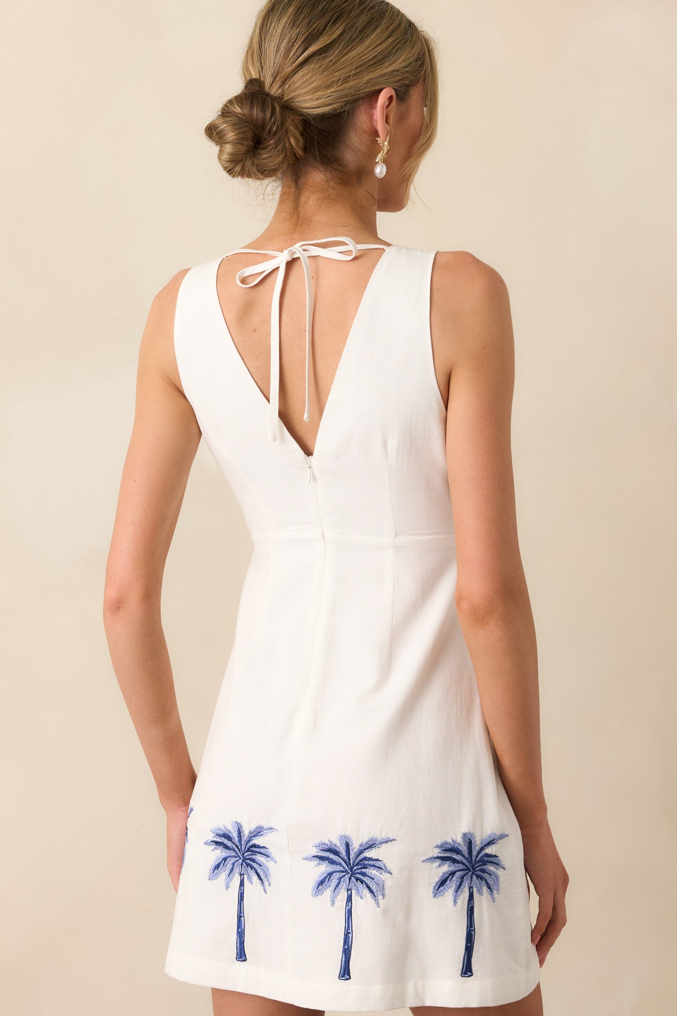 A view from behind of the mini dress, featuring the hidden back zipper and simple sleeveless cut.