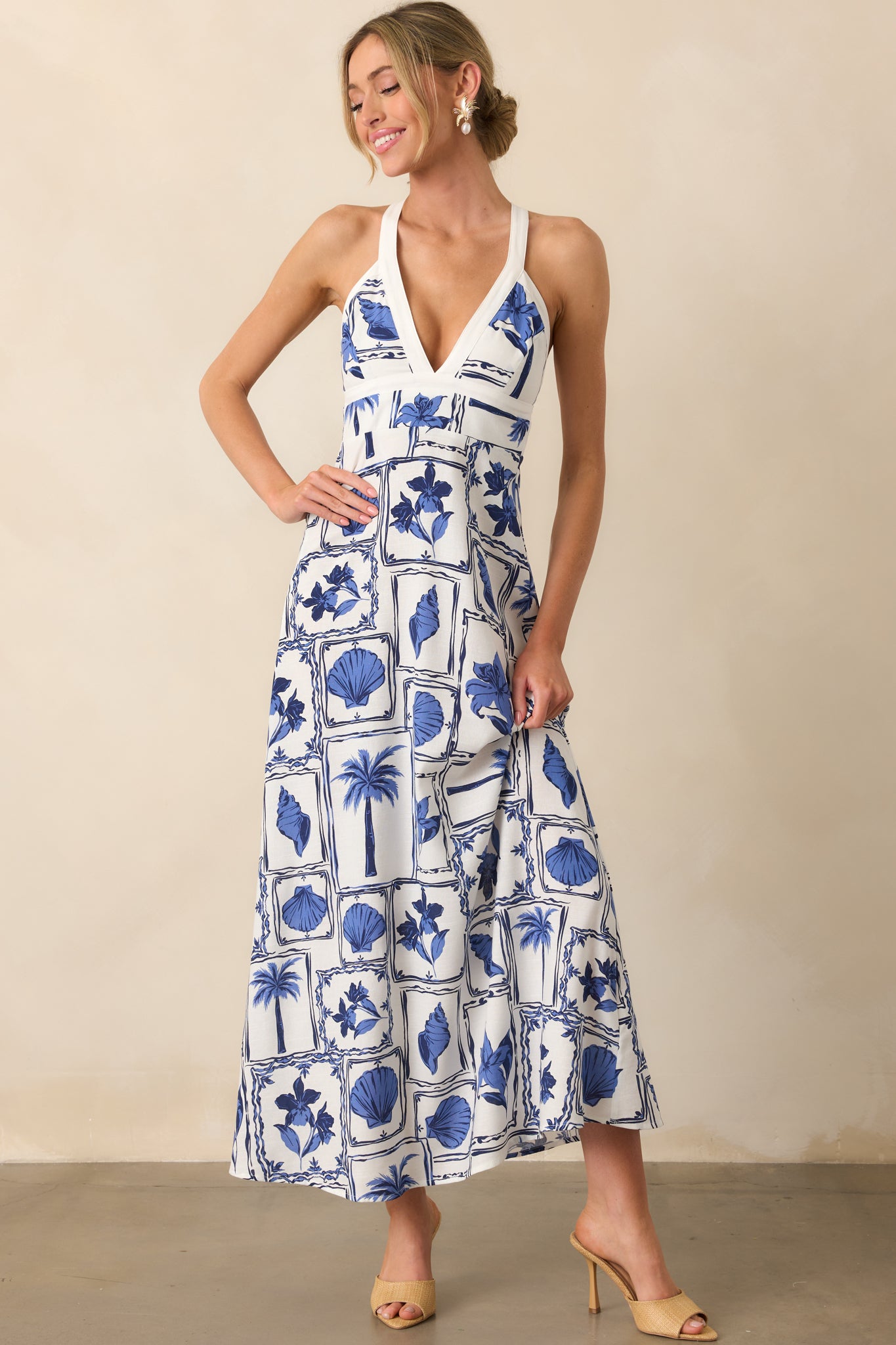 Straight-on view of the dress emphasizing the patchwork print, soft blue tones, and flattering v-neckline.