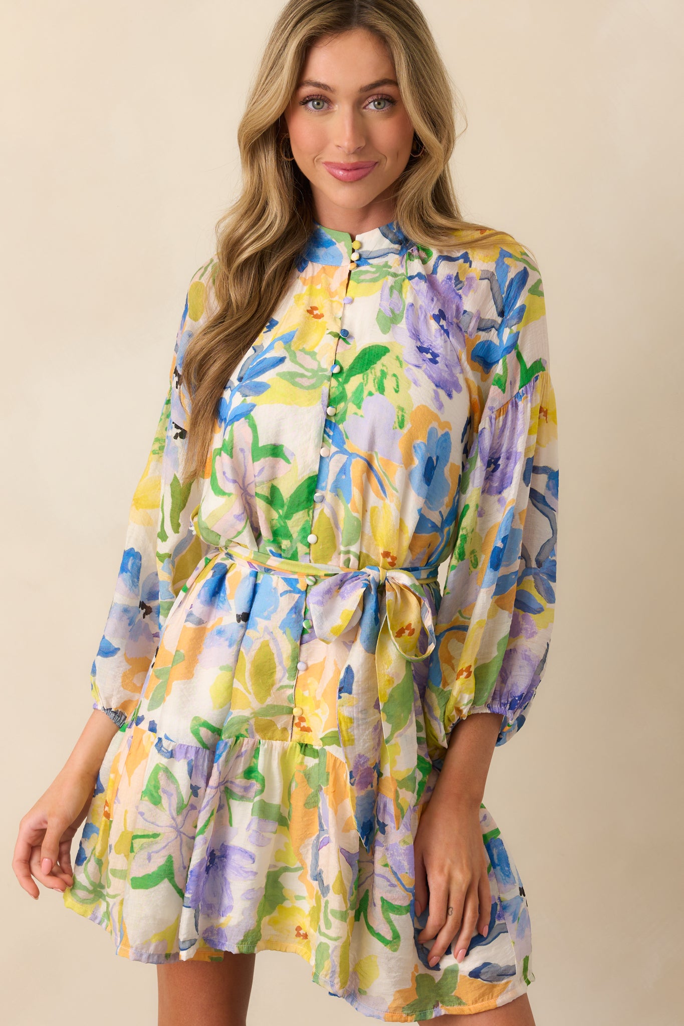 Zoomed-in front view of dress focusing on the bold floral print and gathered sleeves with elastic cuffs.
