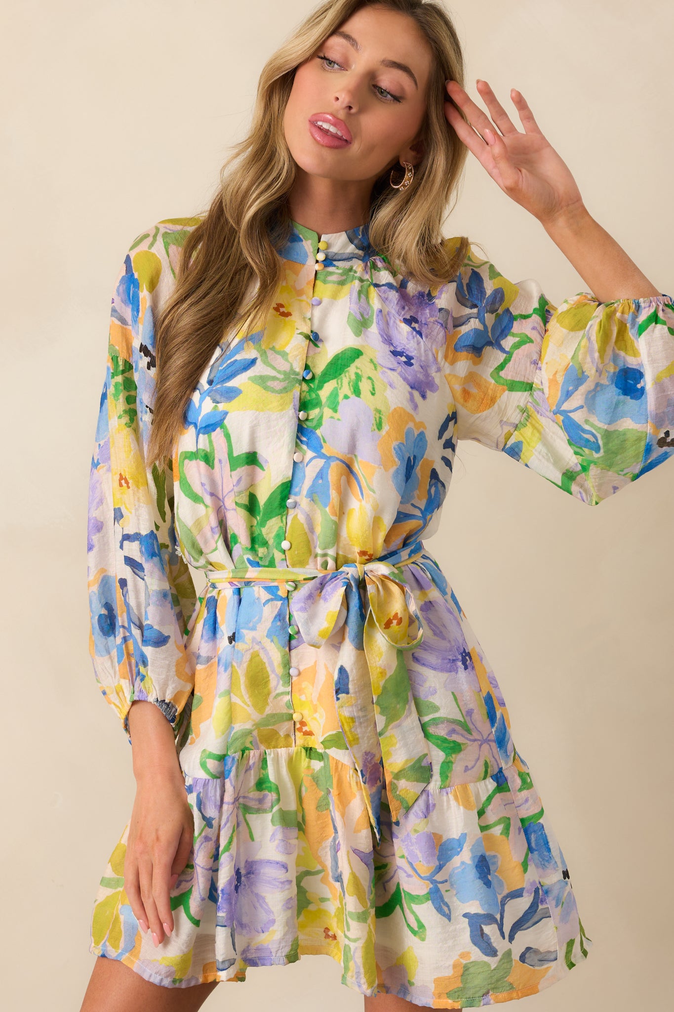 Cropped shot of dress highlighting the waist with optional self-tie belt and part of the front button closure.