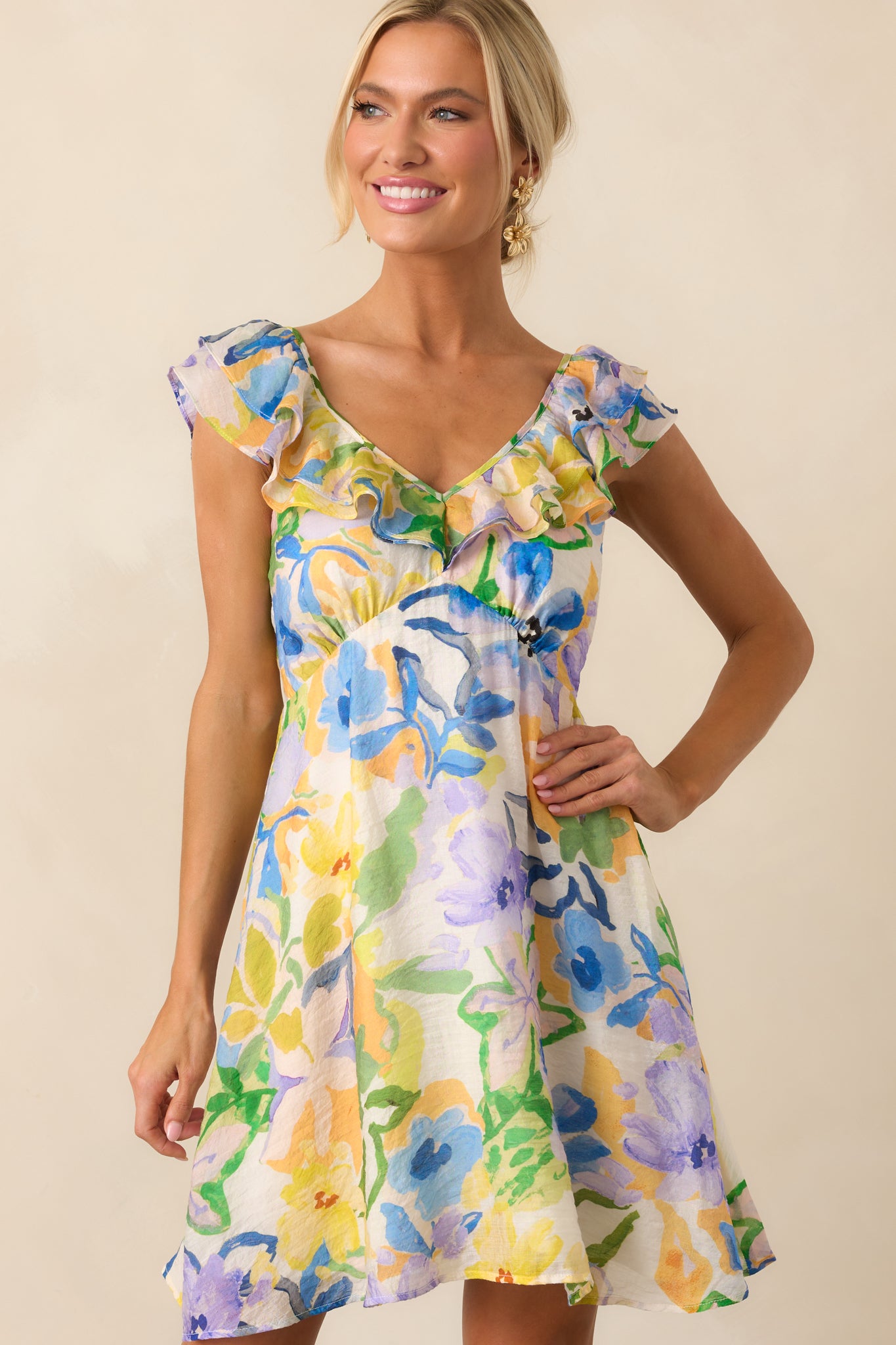 Shorter framed view of the full dress with focus on the allover multicolor floral print and fitted shape.