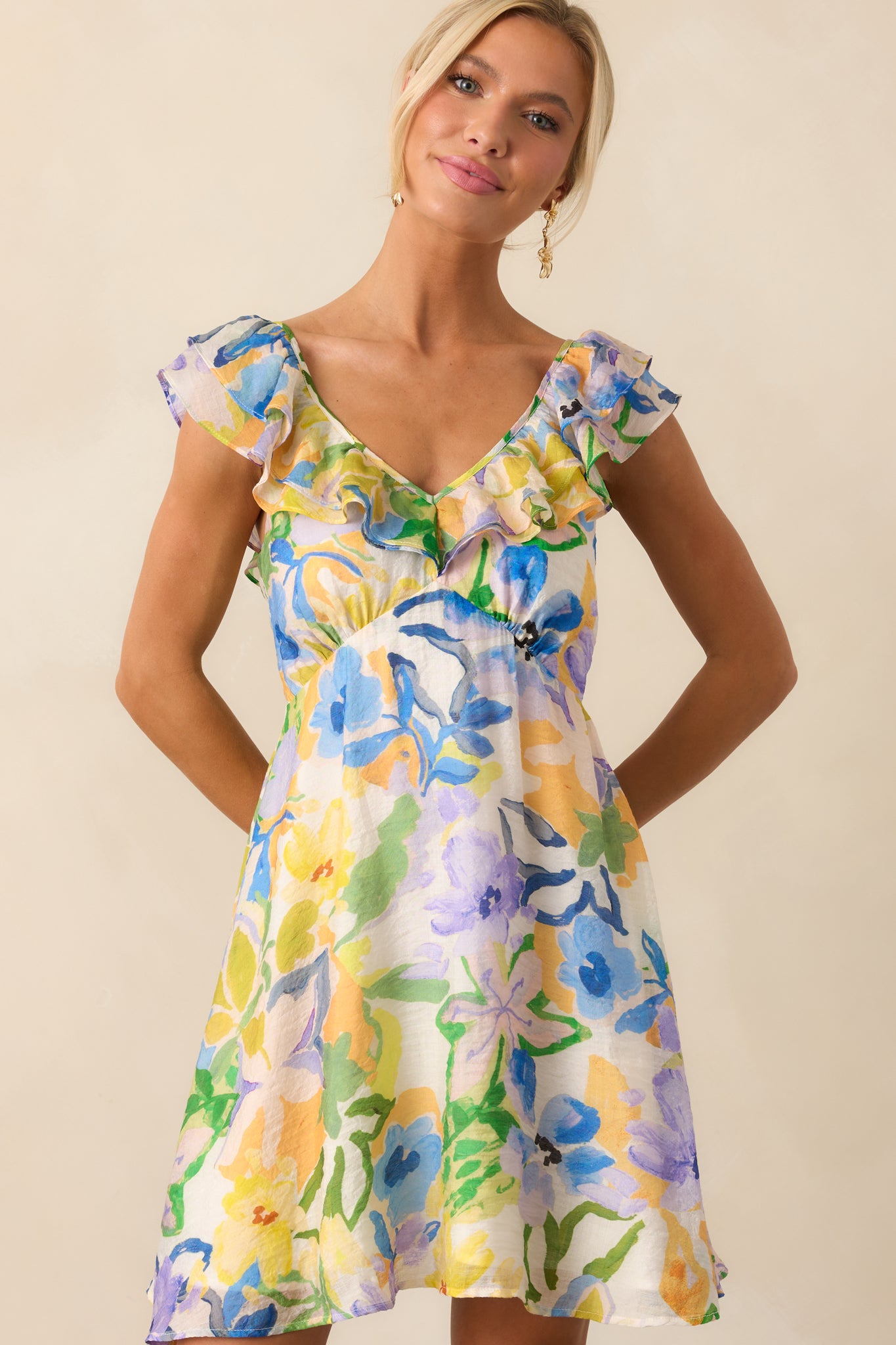 Zoomed-out cropped photo showing the full mini dress, highlighting the cheerful pattern and flared cut.