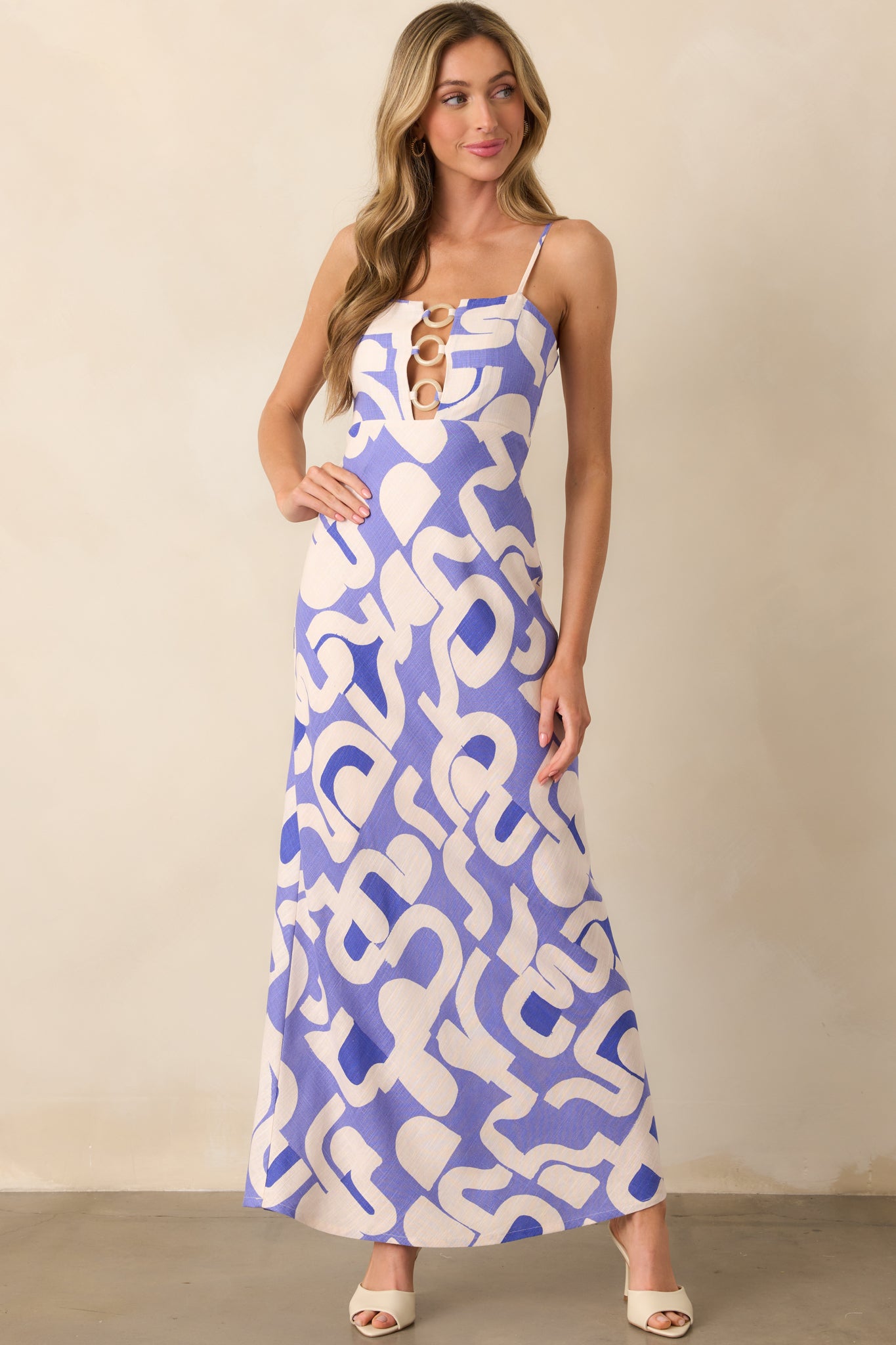 Image of the midi dress from the front, highlighting the square neckline, adjustable straps, and the cutout detail that adds an edgy touch.