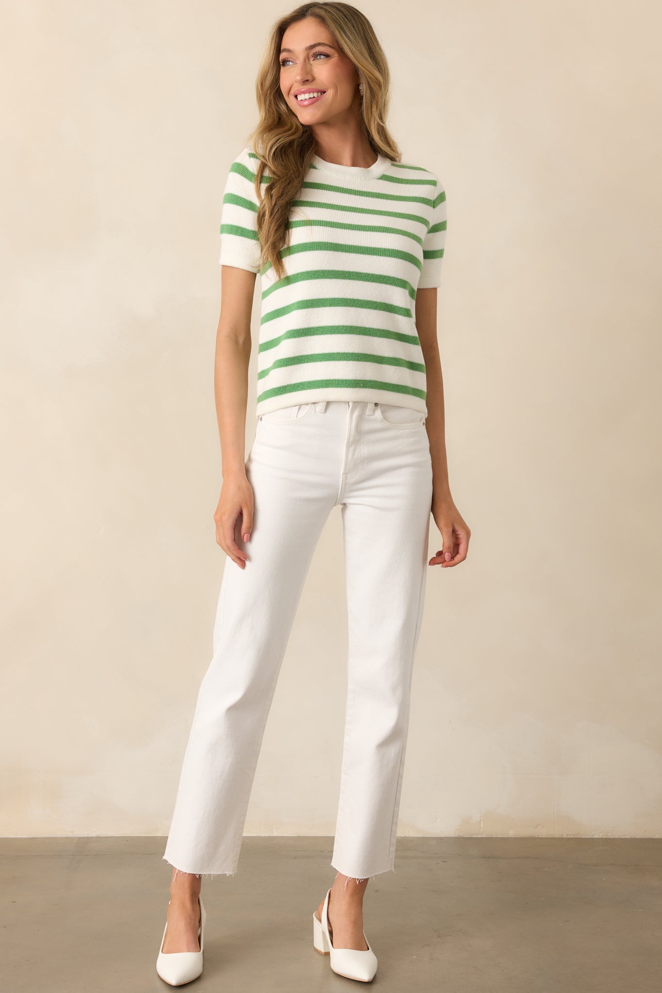 Angled view of the green and ivory striped top showing the relaxed fit and casual shape of the short sleeves.