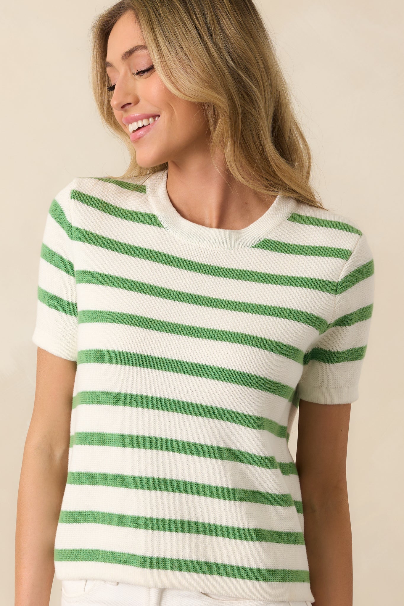 Cropped view showing the sleeve length and texture of the knit fabric in the striped pattern.