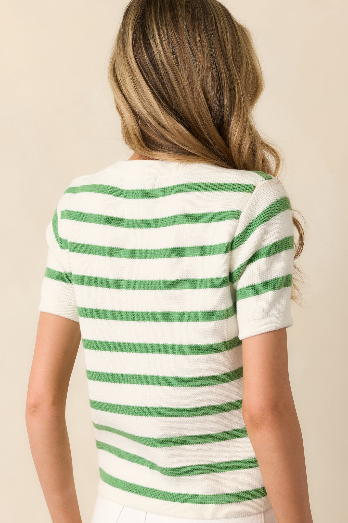Back view of the green and ivory striped sweater, showing the even stripe placement and relaxed fit through the back.