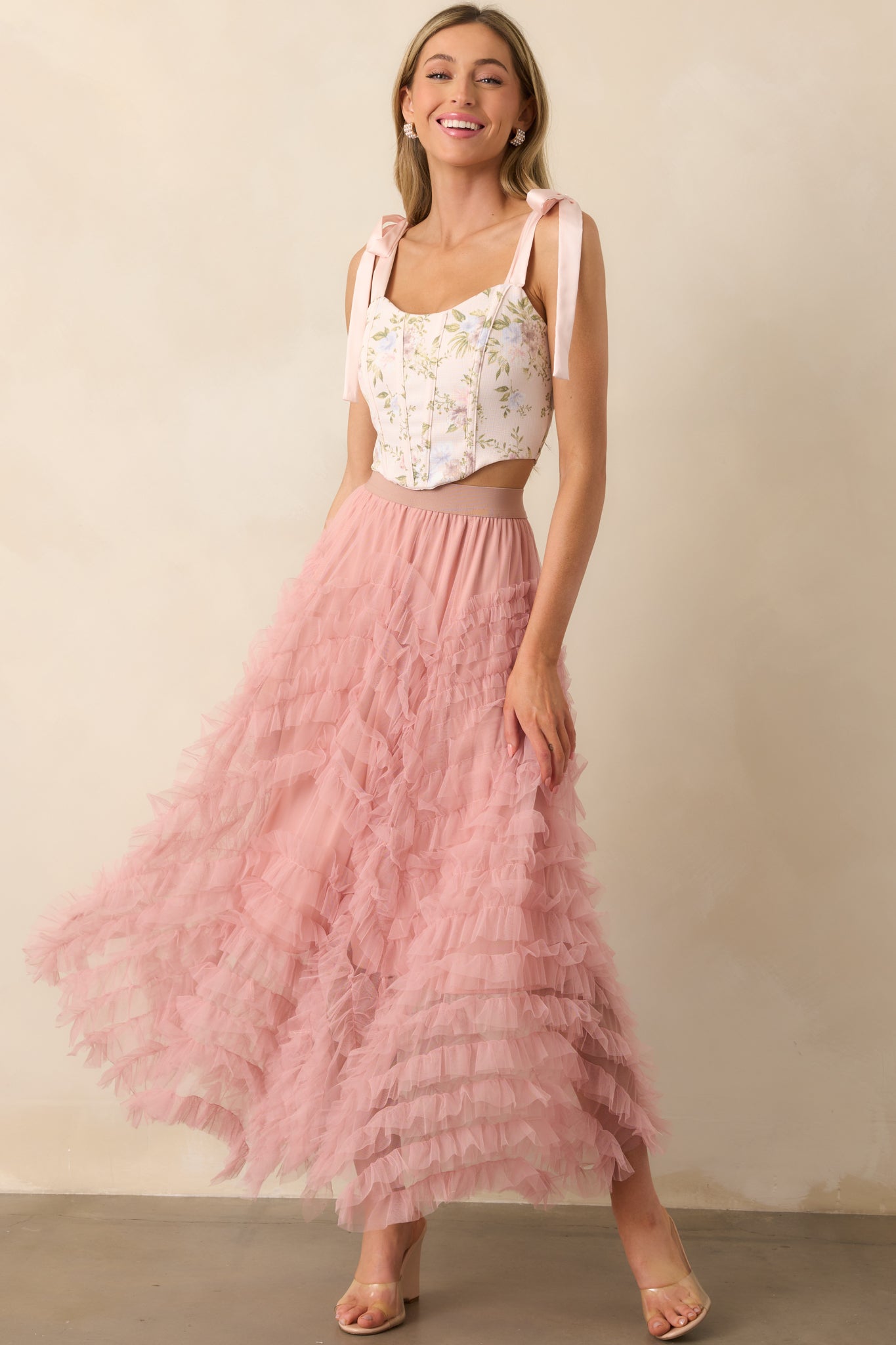 Another full-length image of the pink floral top showing structured corset boning and soft satin shoulder straps.