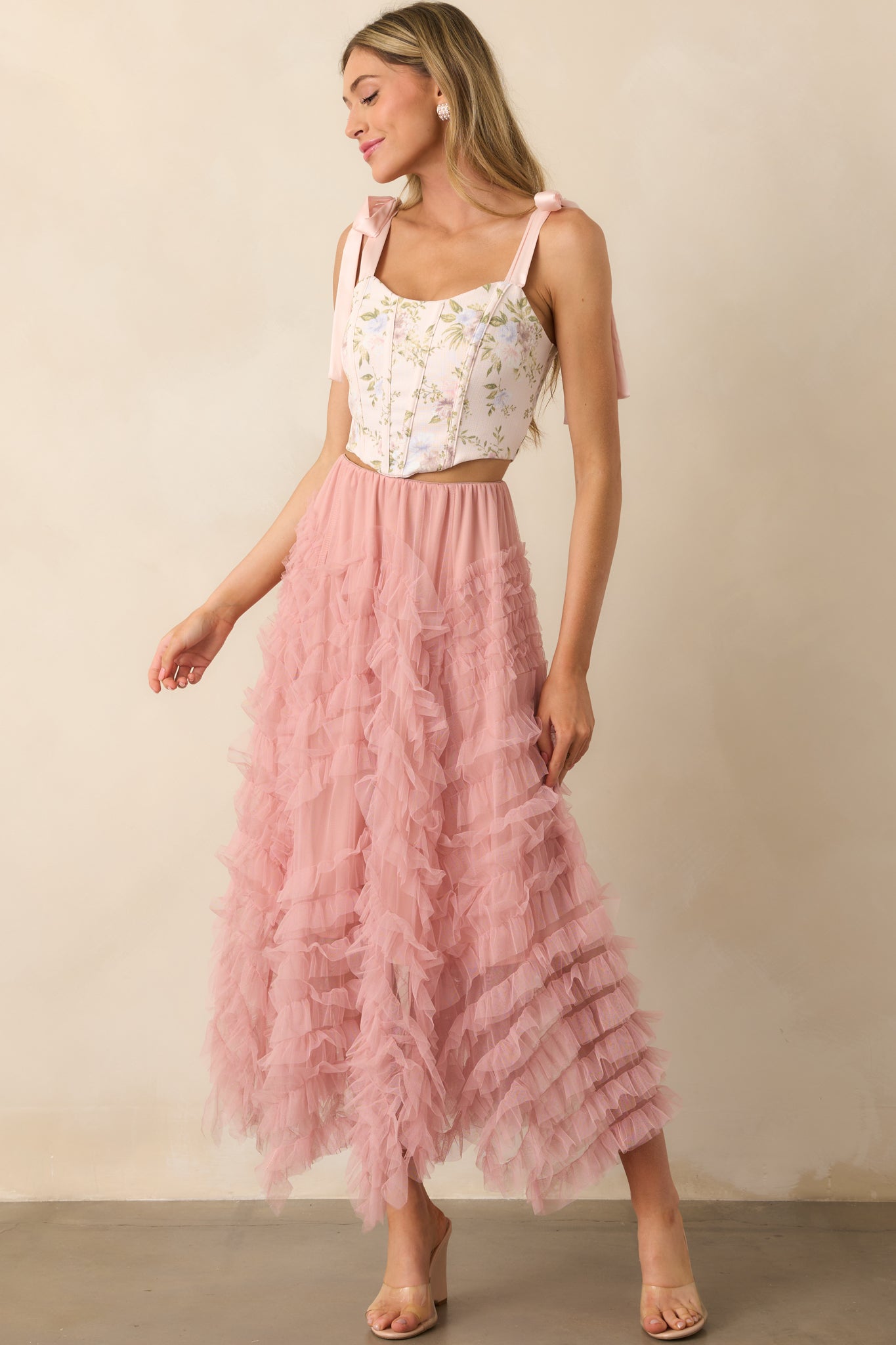 A full body view of the pink floral top showcasing its cropped fit and structured bodice with floral print throughout.