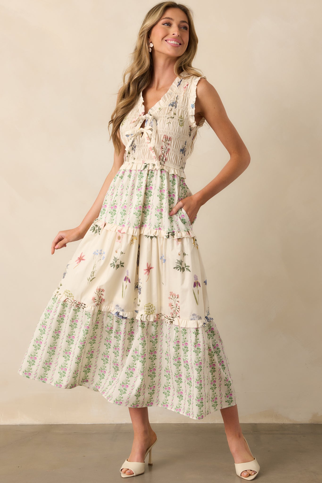 Front view of sleeveless maxi dress highlighting smocked bodice, flowy tiered skirt, and soft ruffle accents.