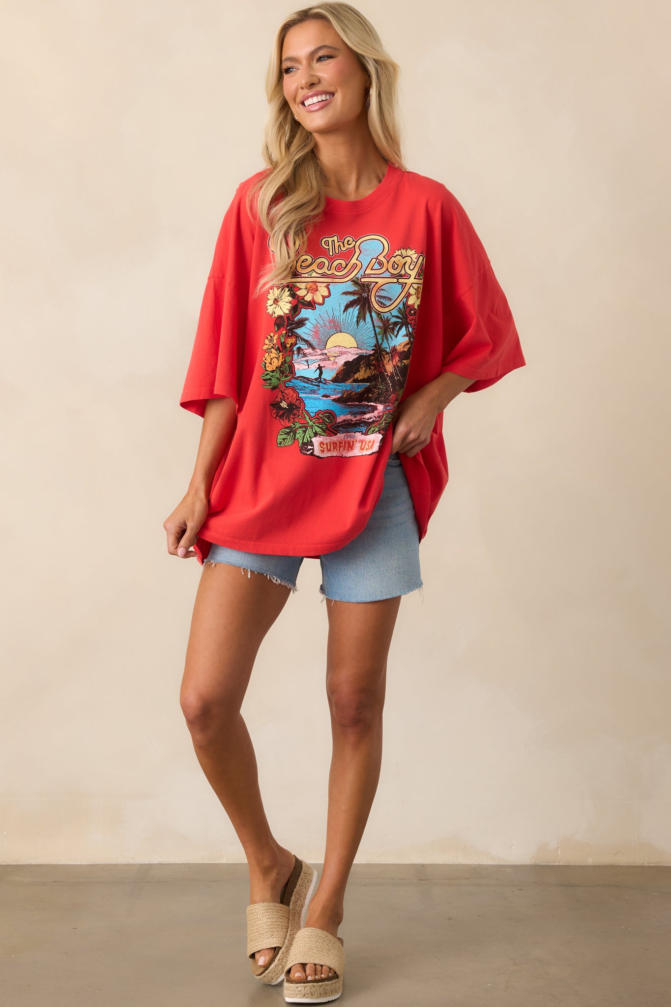 Full body view of red cotton tee showing crew neckline, short sleeves, and bold vintage-inspired graphic.