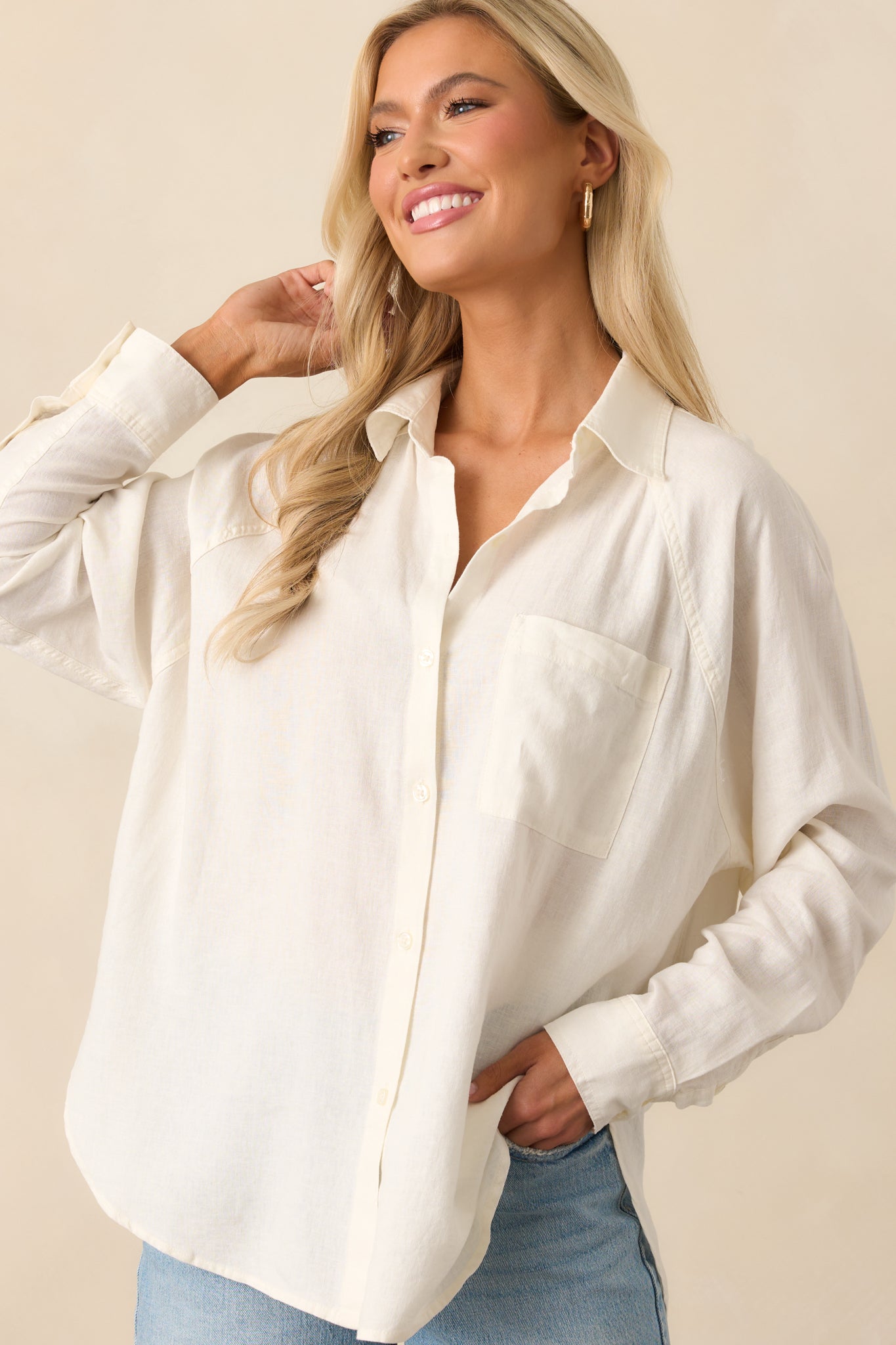 Cropped view of the top’s upper half, showing the collared neckline, functional buttons, and chest pocket detail.