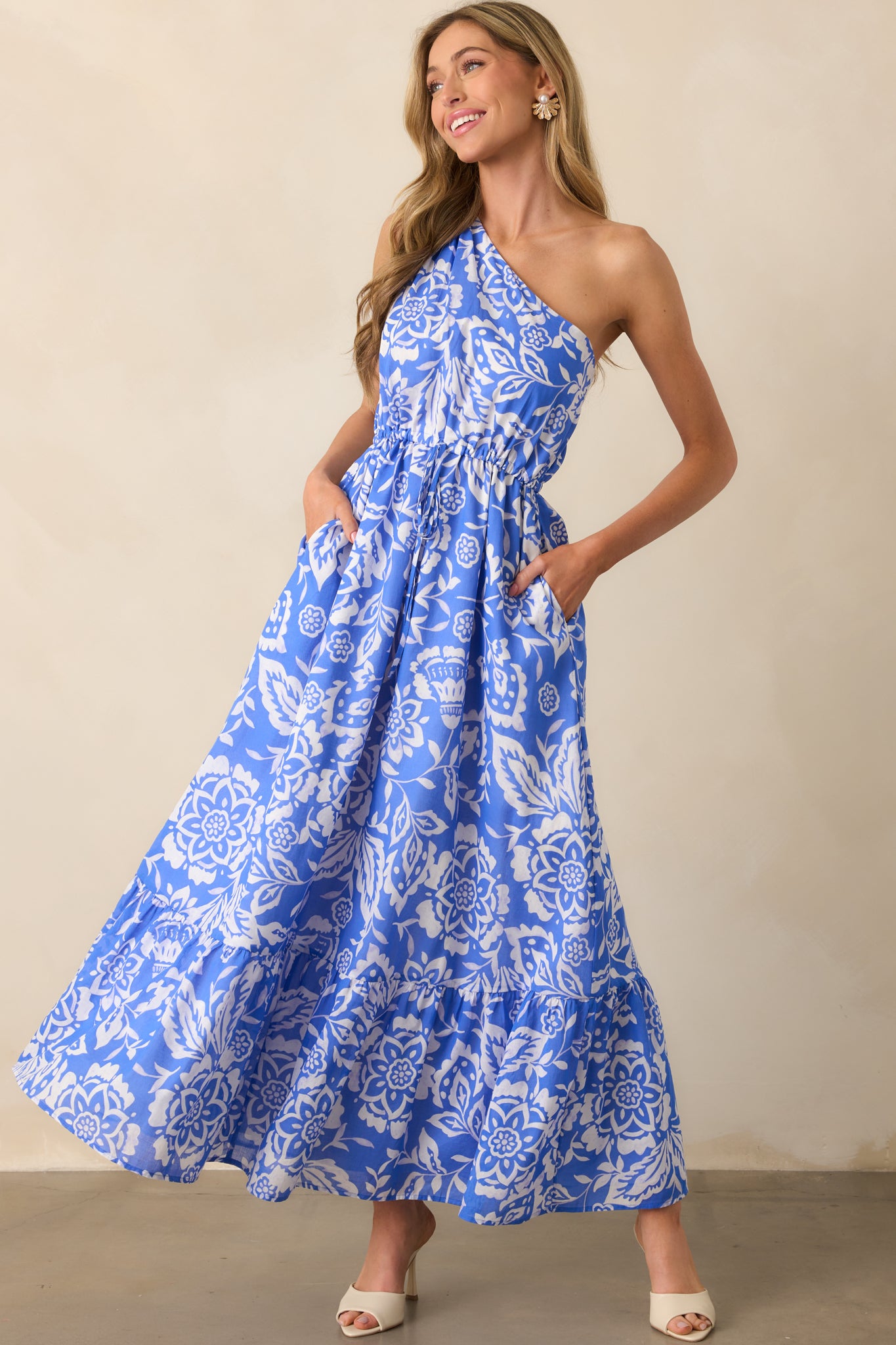 Front-facing full length image of floral printed maxi dress with cinched waist and flowy silhouette.