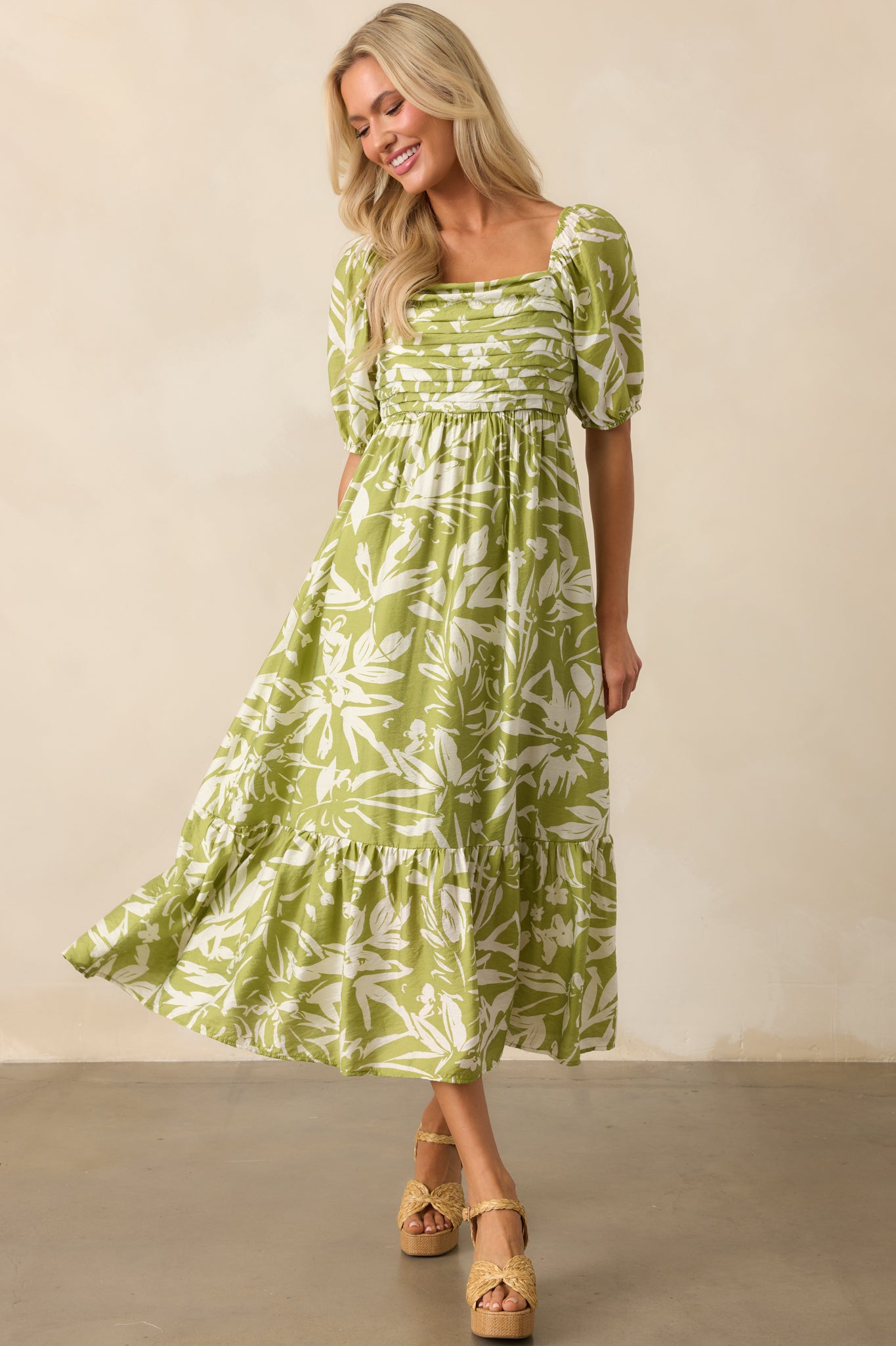 Front view of light chartreuse green dress with ivory floral print and square neckline.