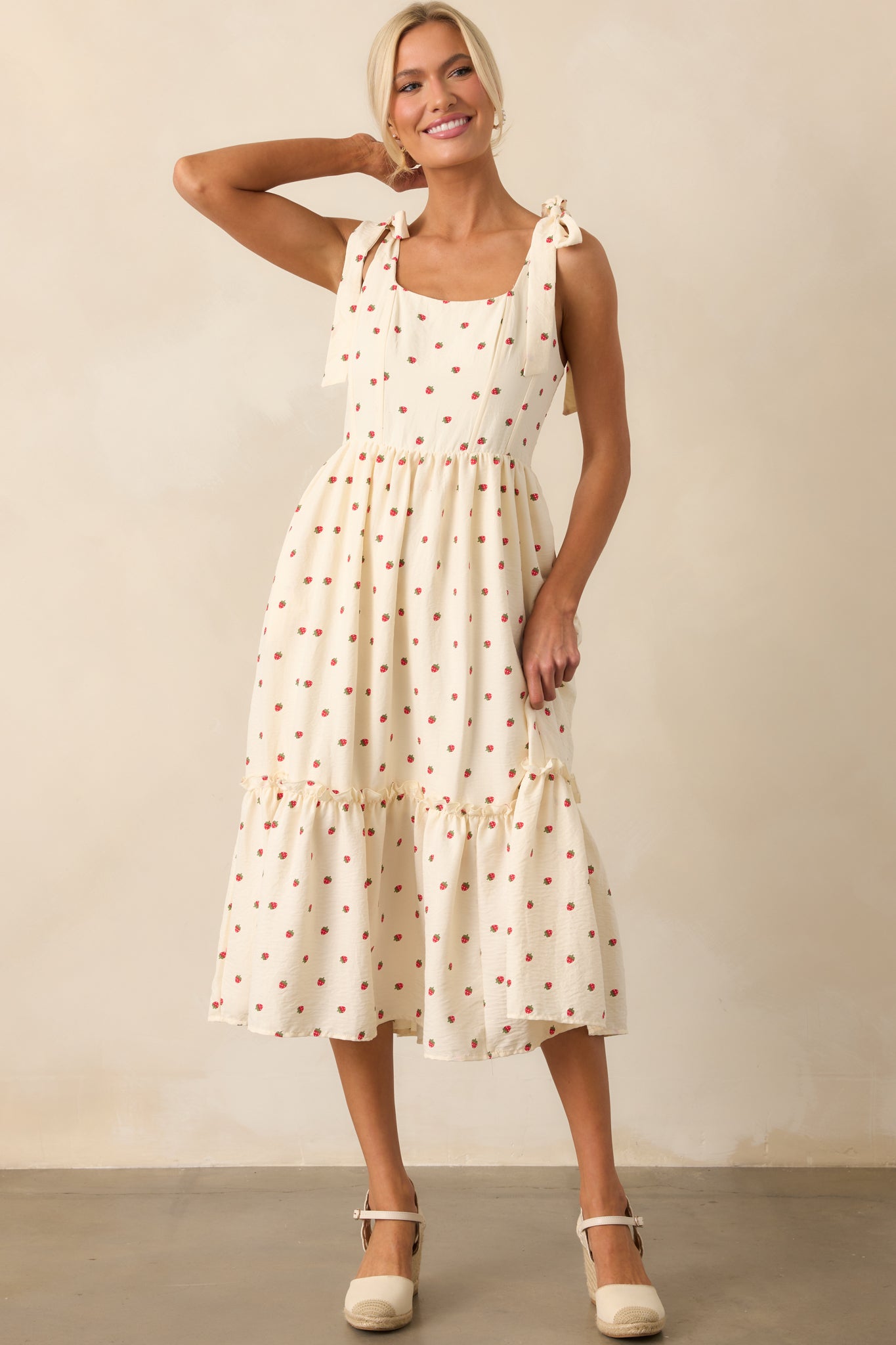 A full-length image showcasing the tiered skirt and panel bodice design of the ivory strawberry print dress.