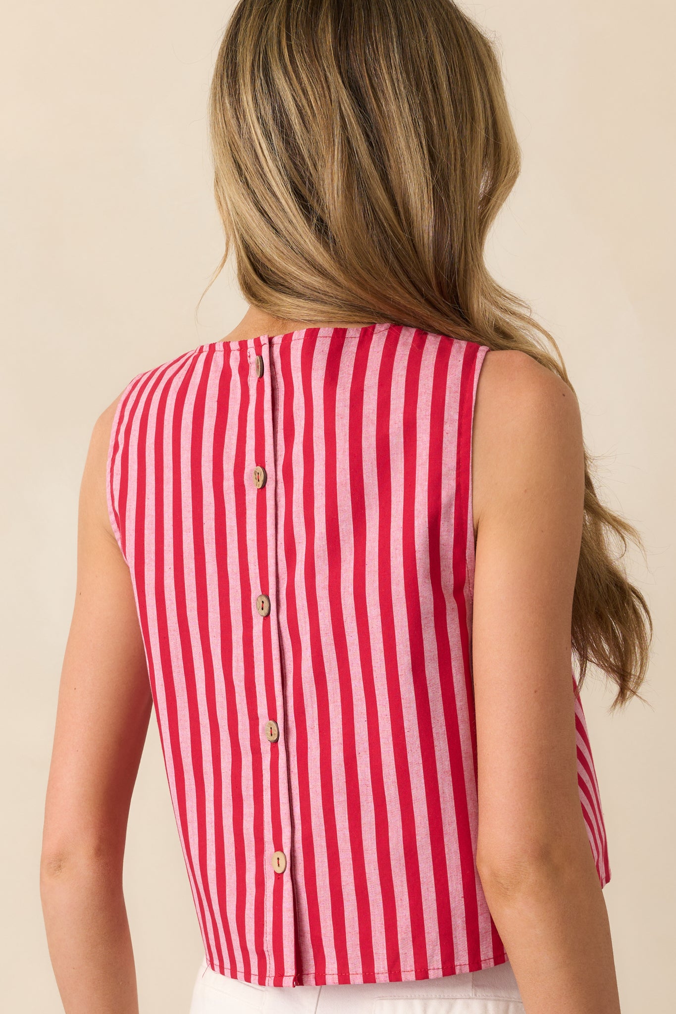 A view from behind of the red top, focusing on the functional button closures and continuation of the stripe print.