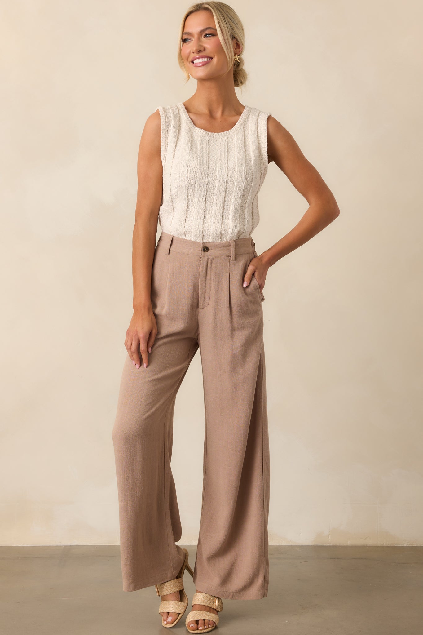 Tan iced coffee pleated pants with wide legs, shown in a full body front view, highlighting the relaxed fit and lightweight fabric.