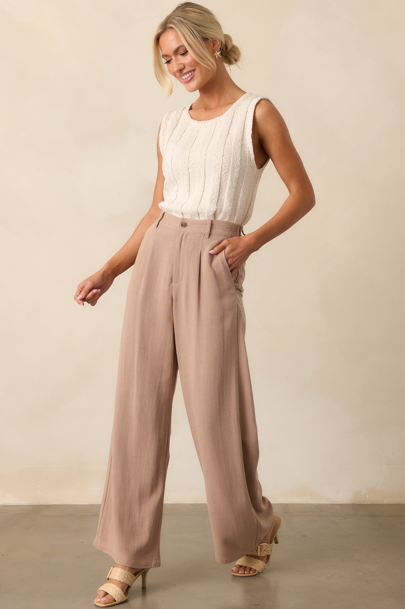 Full length image of the pants showcasing the high-rise fit, pleated wide legs, and relaxed drape of the lightweight linen blend fabric.