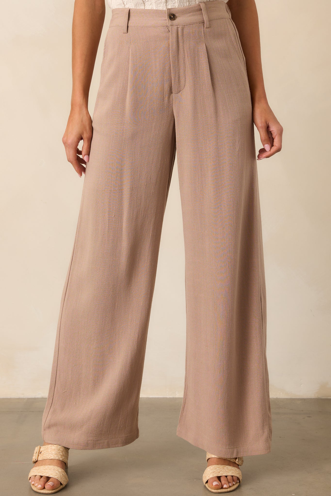 Detailed view of the wide leg design and pleats on the tan iced coffee pants, highlighting the soft linen blend fabric.