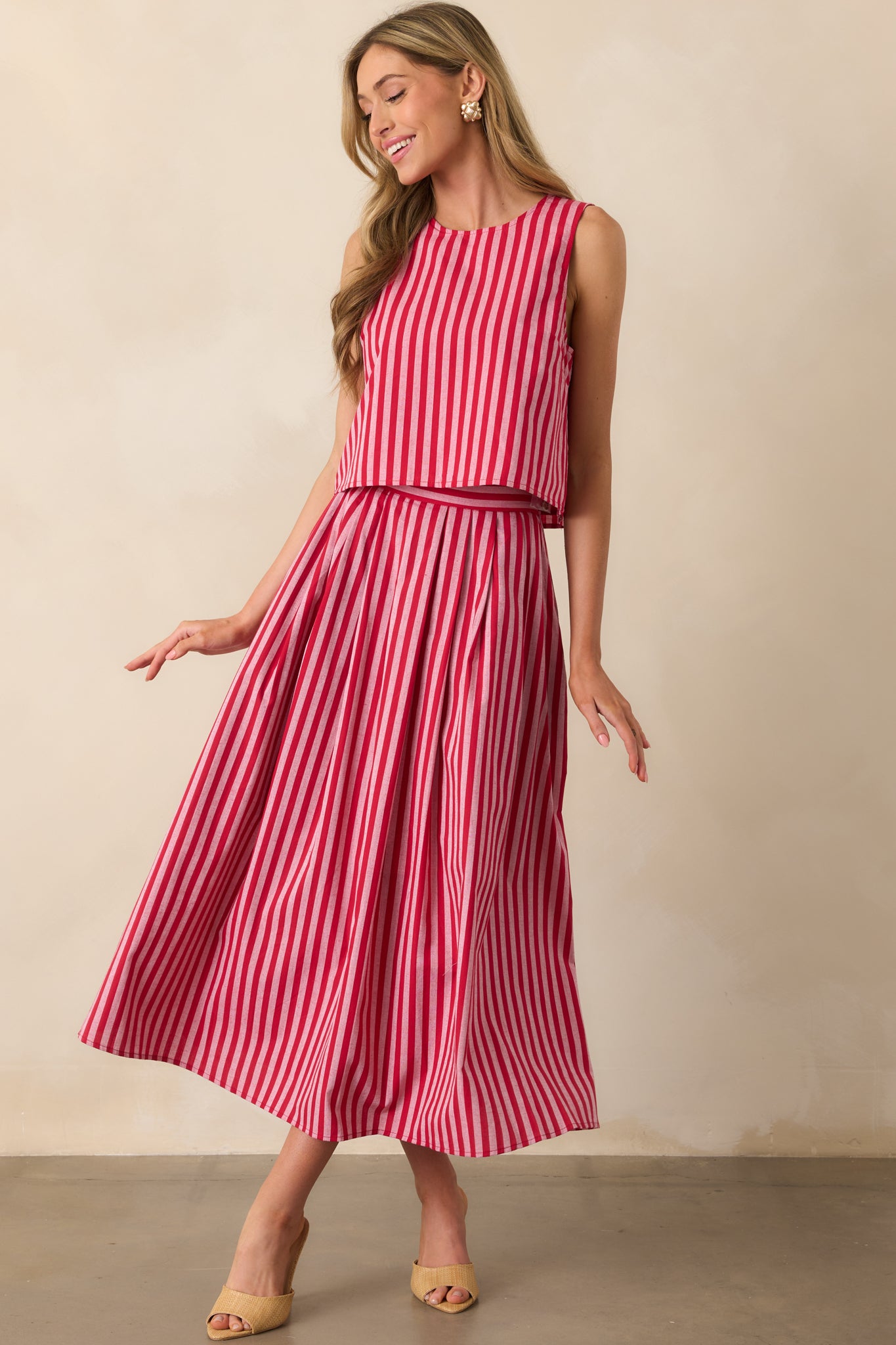 Front-facing view of a red striped top featuring a sleeveless design and airy cropped cut.