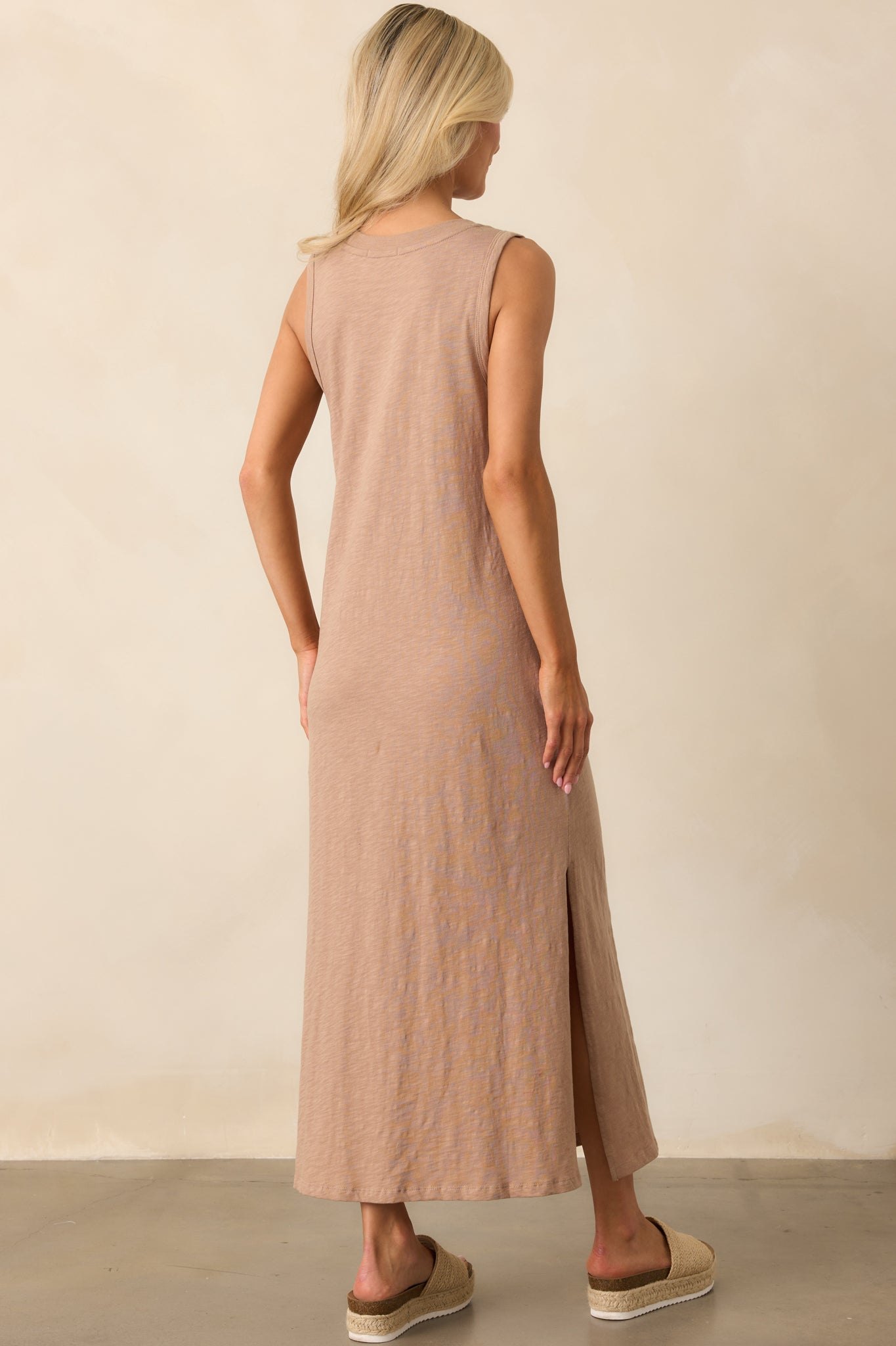 Back view of the tan iced coffee dress, showcasing the simple, sleeveless design and the fluid fall of the fabric.