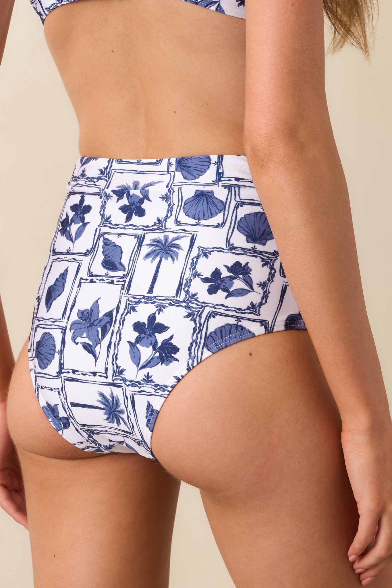 A view from behind of the bikini bottoms showing medium to full coverage and continuous beach motif print.