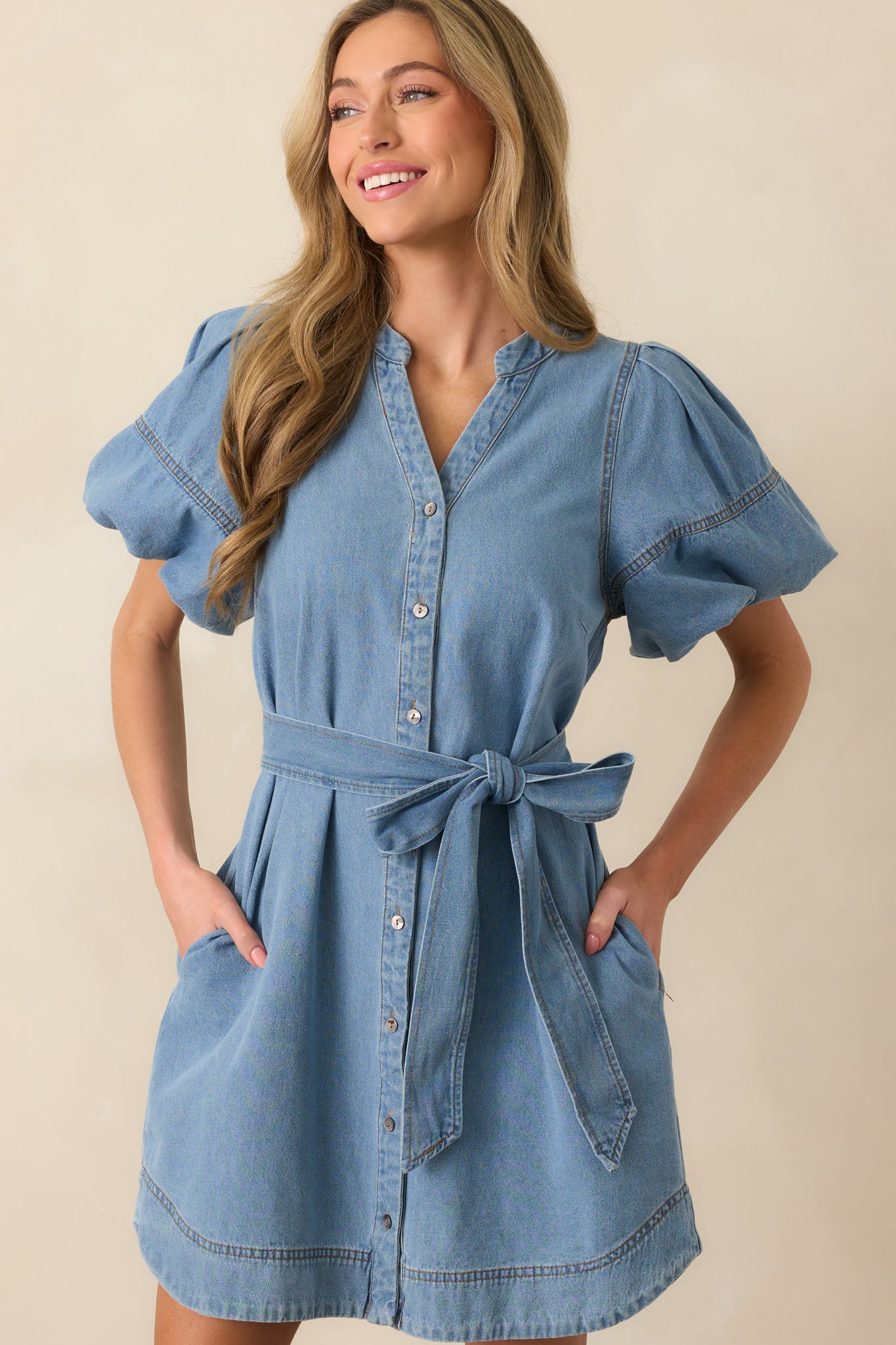 Close crop highlighting the dress's front button closure and subtle seam details along the bodice.