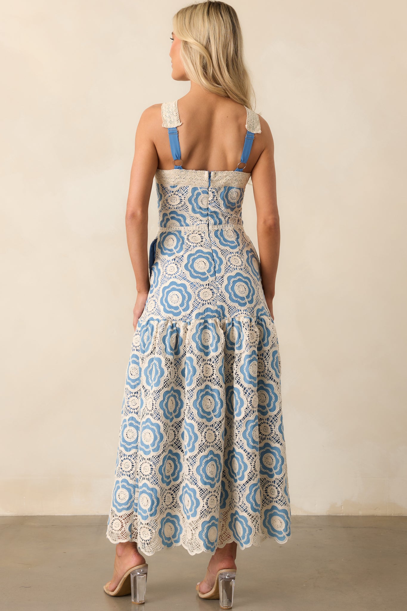 A view from behind of the dress, featuring the hidden zipper and adjustable cross strap detail.