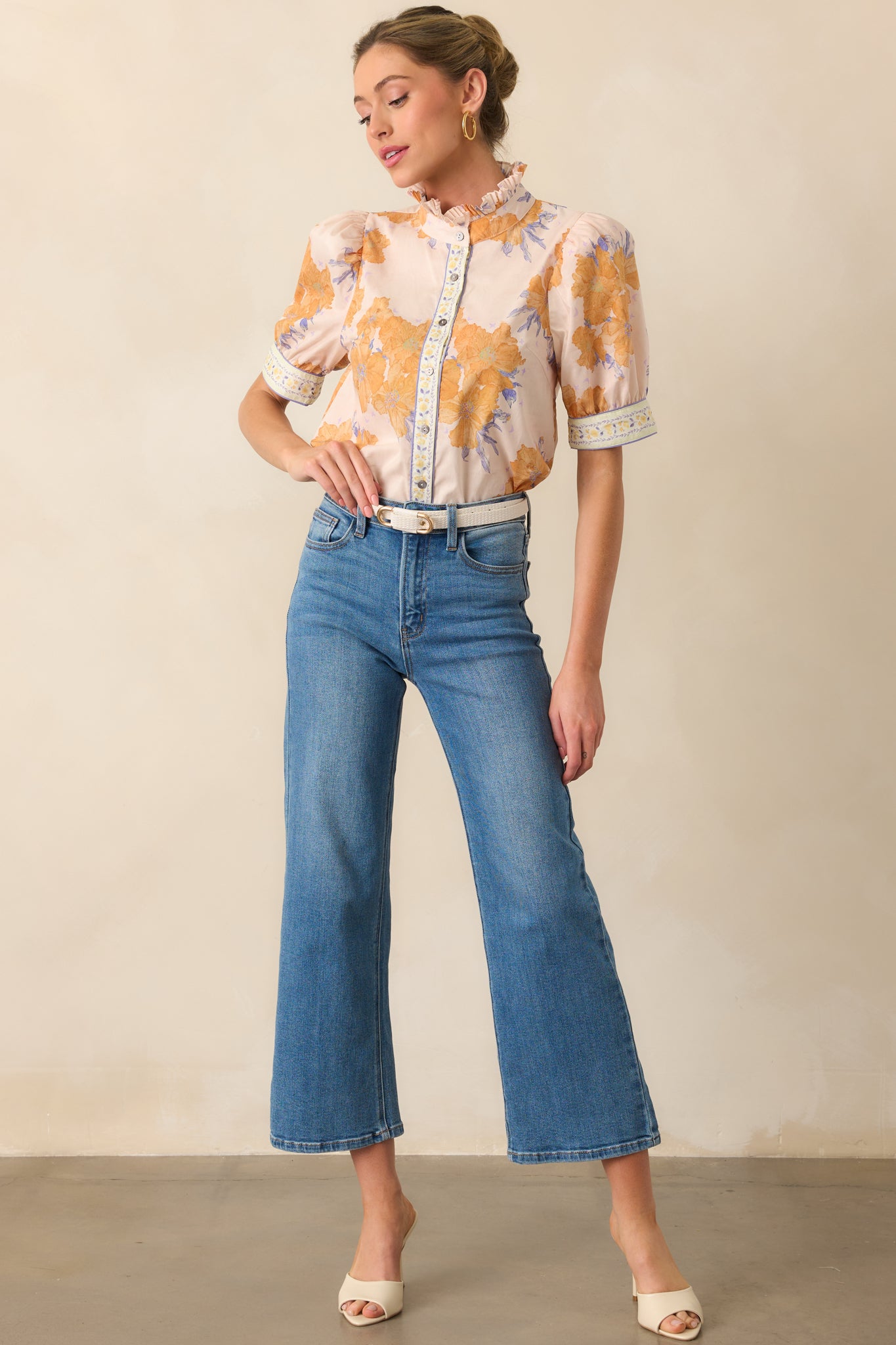 A full-length image showcasing the floral printed honey yellow top with cuffed short sleeves and contrast trim detailing.