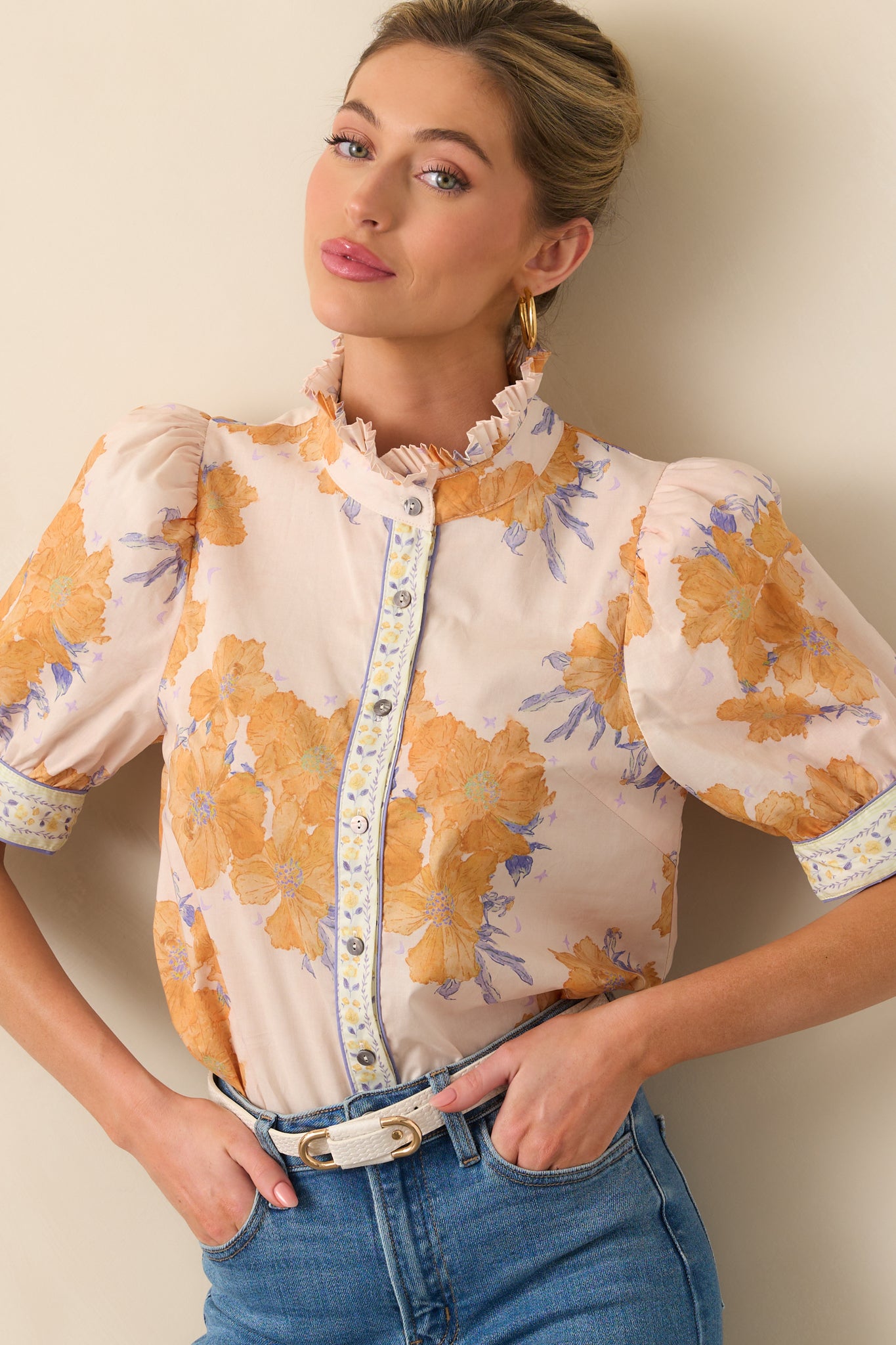 A cropped view focusing on the button front closure and detailed floral print of the honey yellow top.