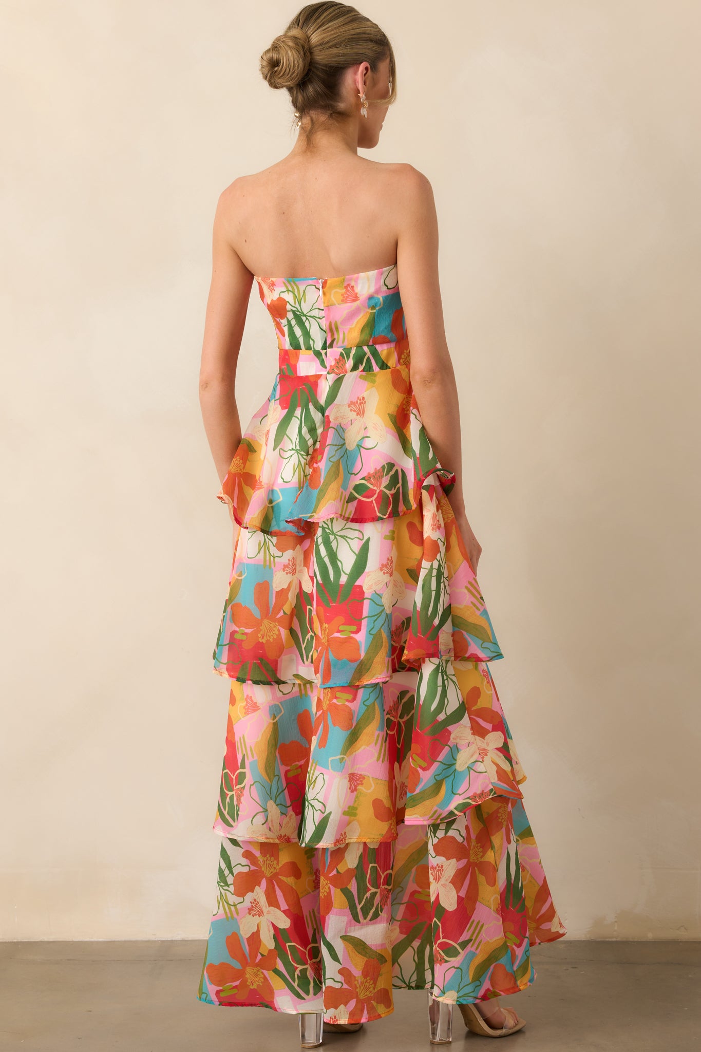 A view from behind showing the discrete zipper closure and continuation of the colorful tropical print.