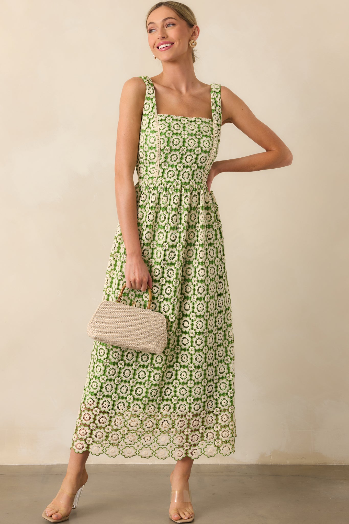 Green dress with a discrete side zipper, two functional side pockets, and a beige and green floral embroidered overlay.