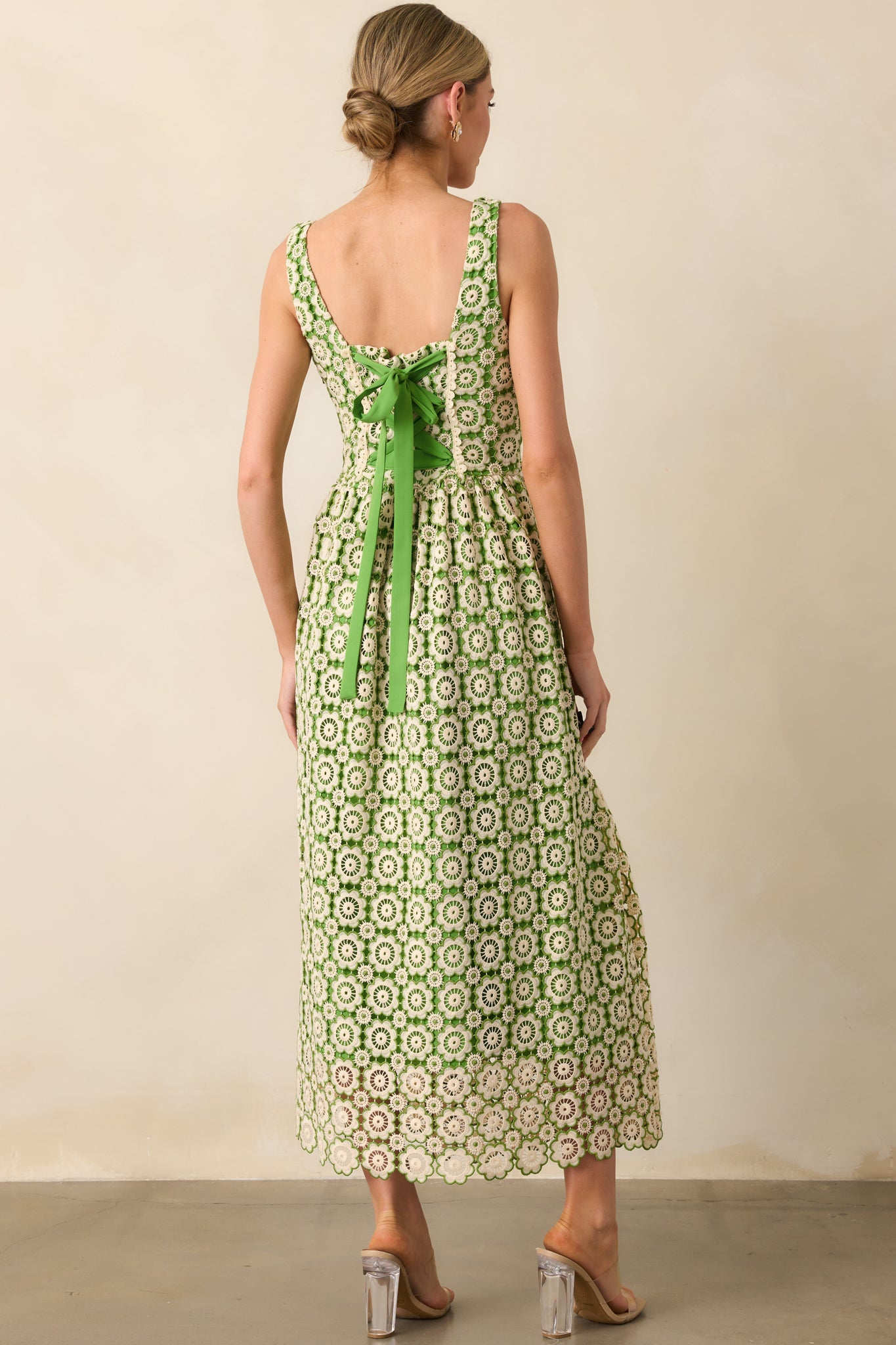 A view from behind showing the self-tie green bow and the smooth back with the discrete zipper.