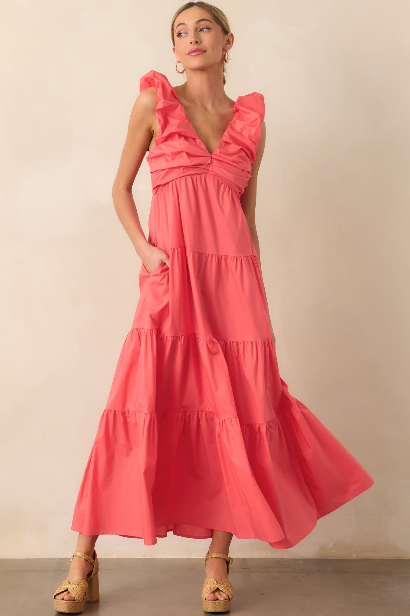 Pink coral dress shown front-facing with visible functional pockets and flowy cotton fabric.