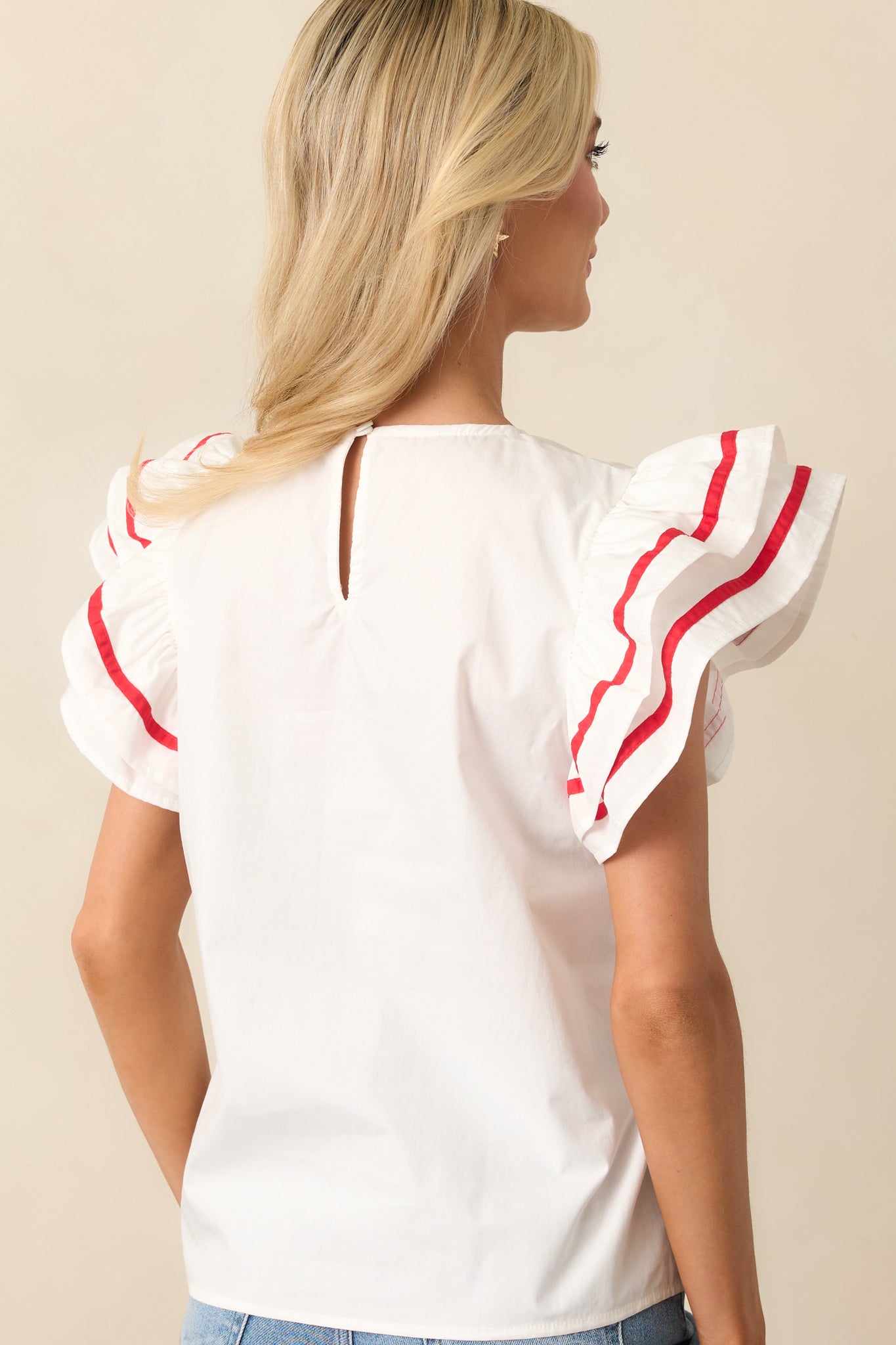 A back view of the top showing the keyhole closure and softly gathered fabric around the neckline.