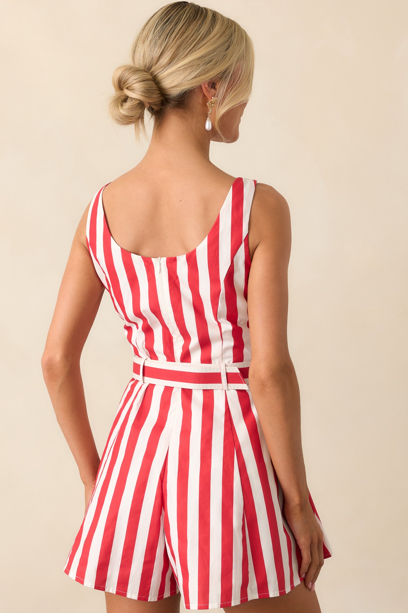 A back view of the romper featuring a discreet back zipper and clean finish across the shoulders and waistline.