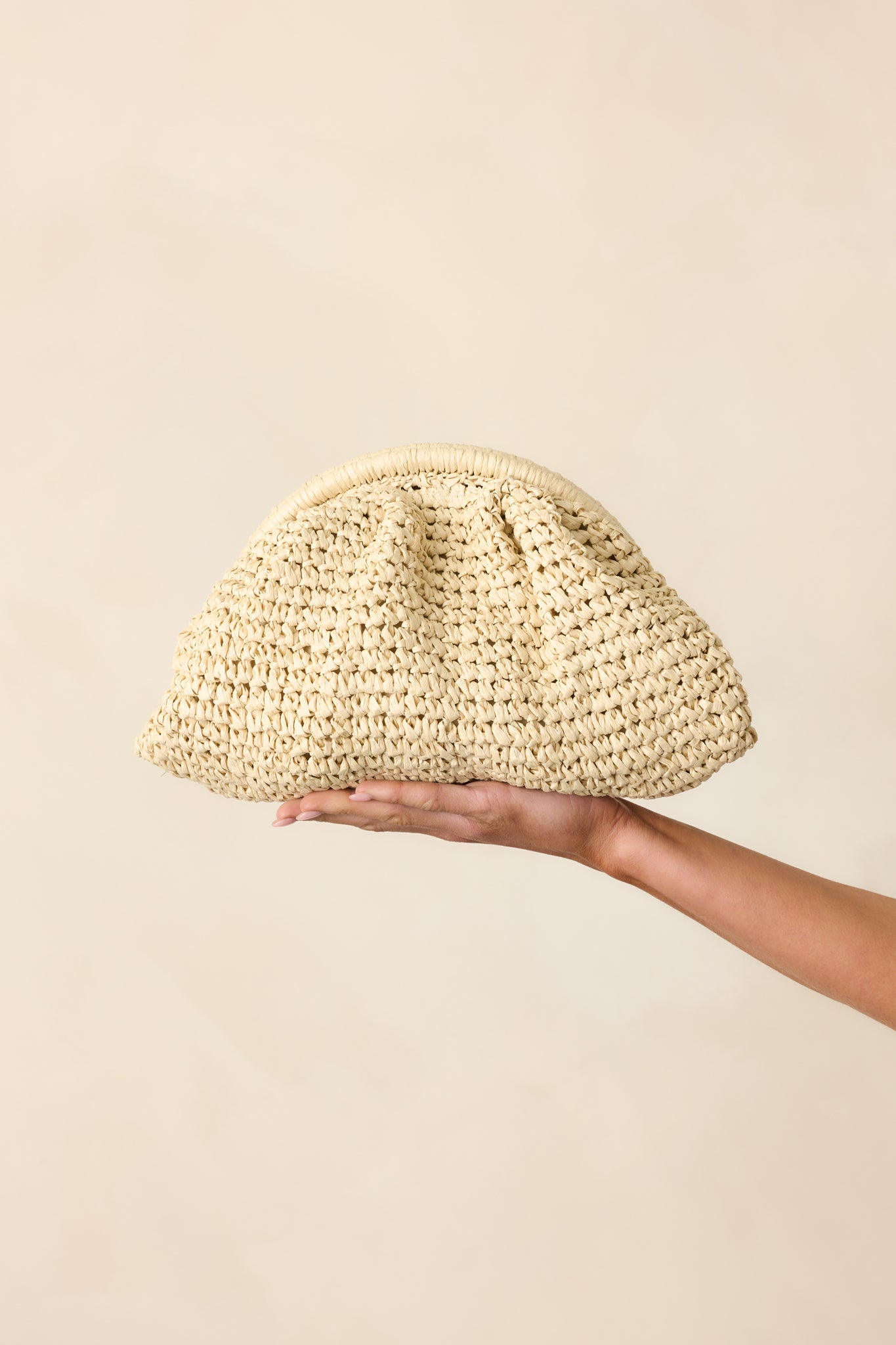 Closer look at the handbag’s top section, showing the hinge clasp closure and hints of the gold crossbody chain.