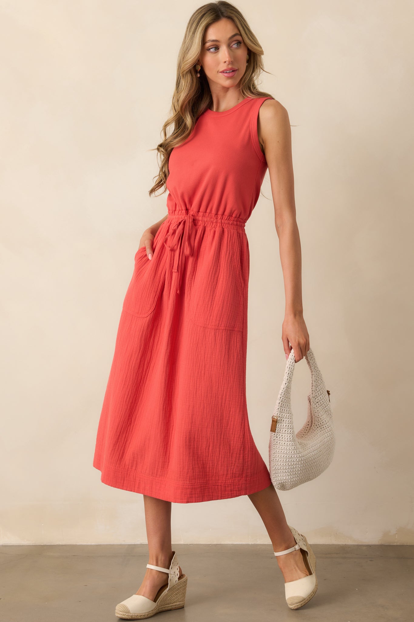 Full-length image showing the red dress with an elastic waistband and adjustable self-tie drawstring for a cinched silhouette.