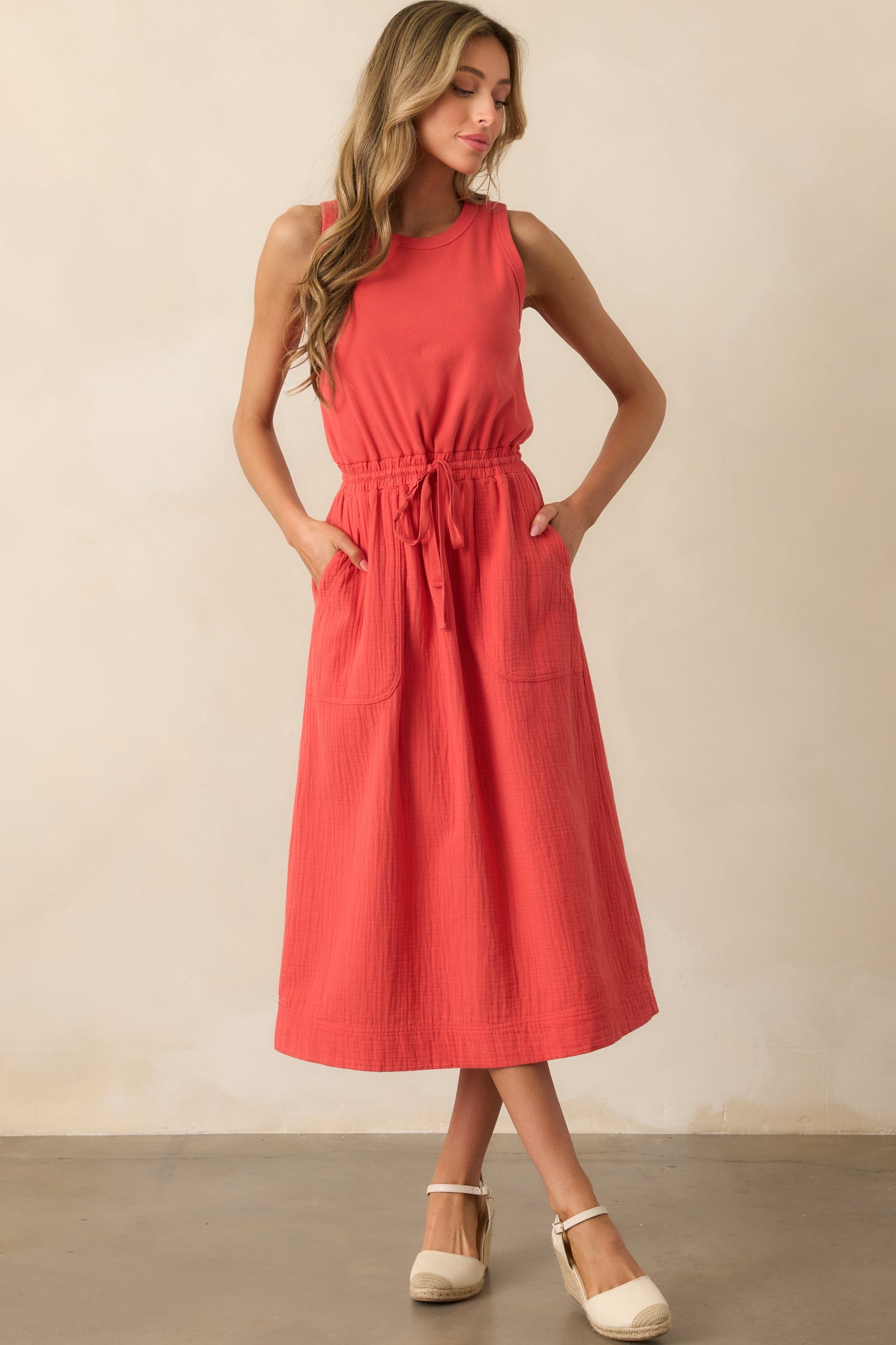 Red midi dress styled front-on, highlighting the texture contrast between the ribbed top and gauze skirt.