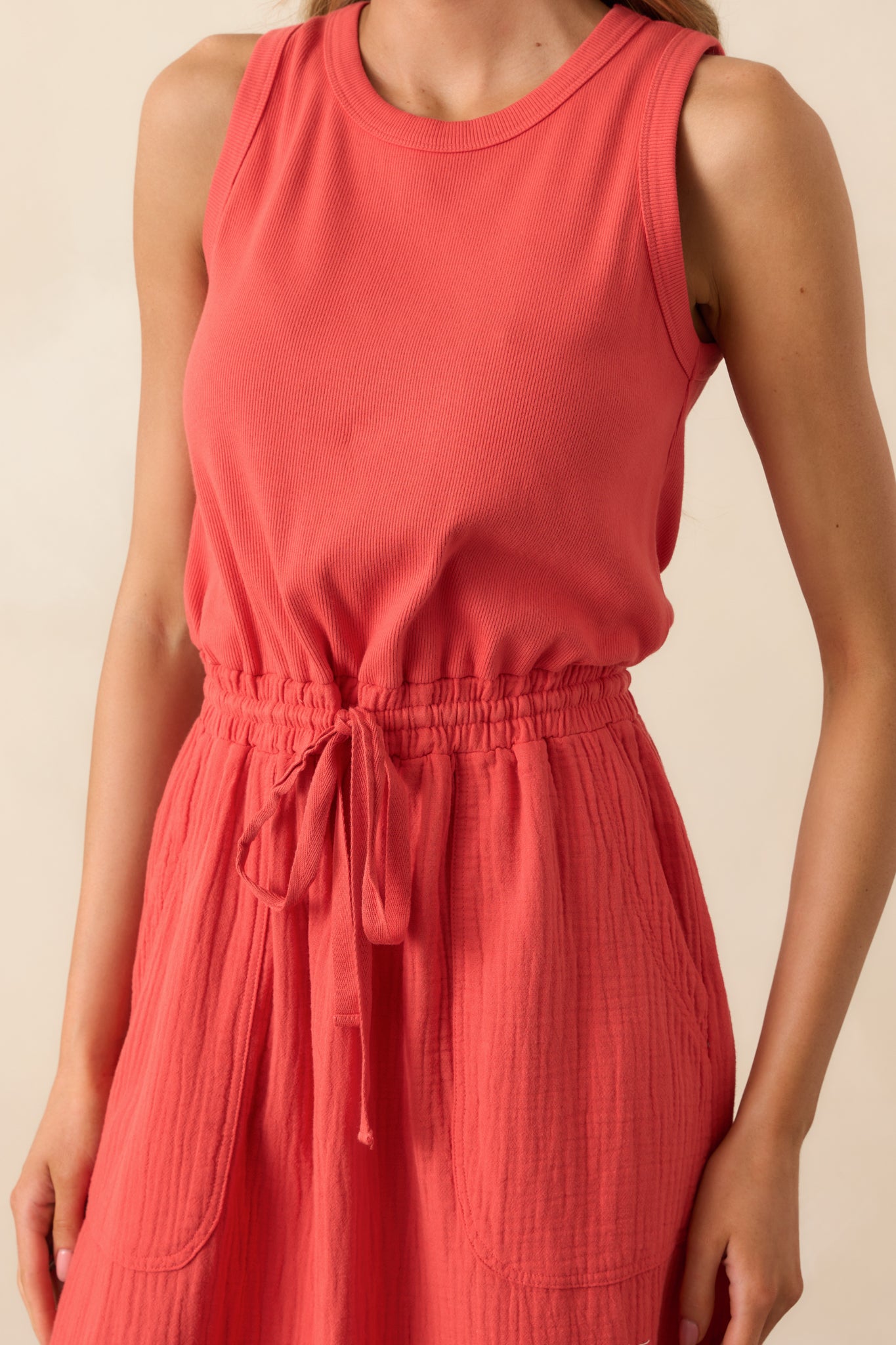 Close-up of the dress showing the ribbed texture of the bodice, drawstring tie at the elastic waist, and subtle gauze weave of the skirt.
