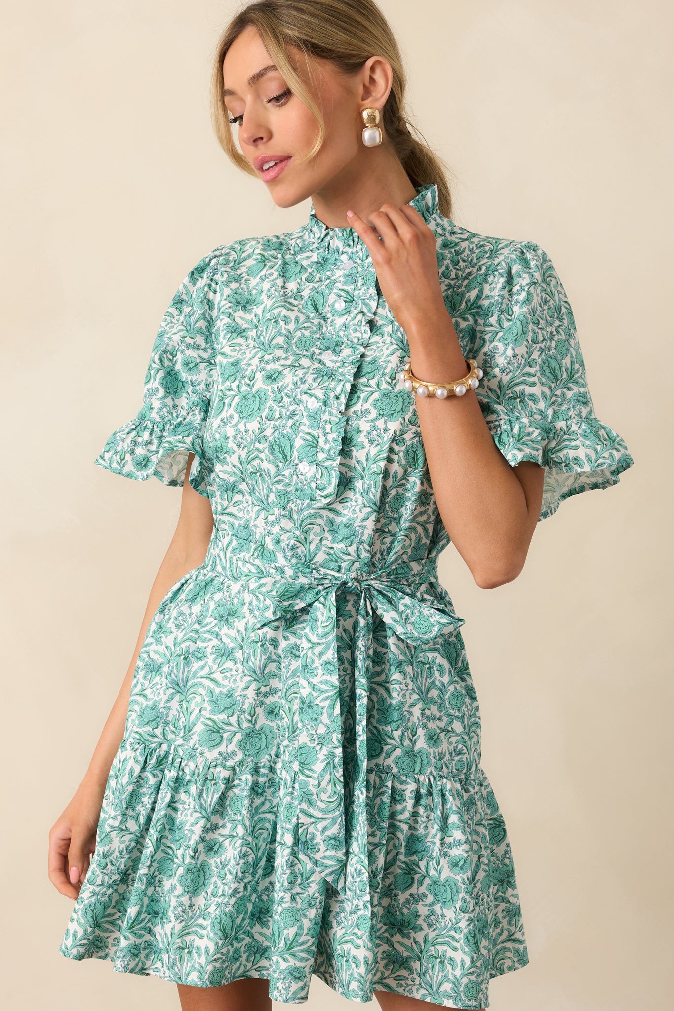 Teal green mini dress with a high ruffle neckline and tiered skirt, shown in a full body front view.
