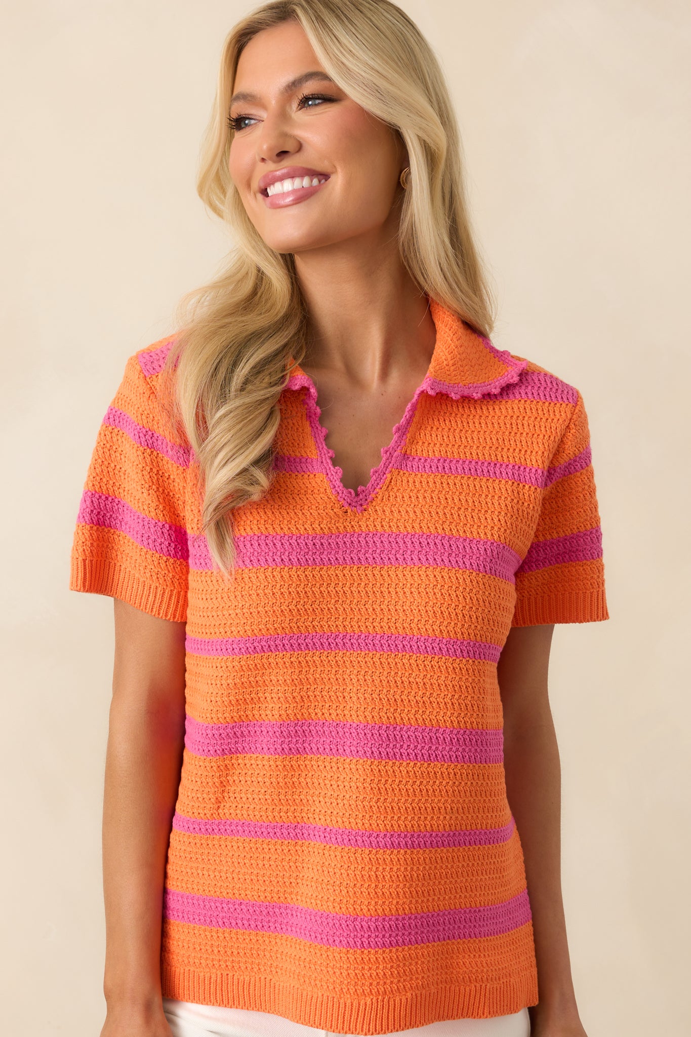 Cropped view of the bottom hem of the striped top, focusing on the drape and relaxed fit.