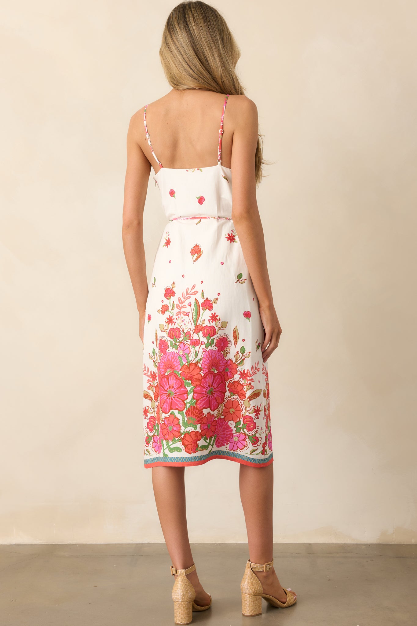 A view from behind of the magenta dress, showing the adjustable straps and discreet back zipper.