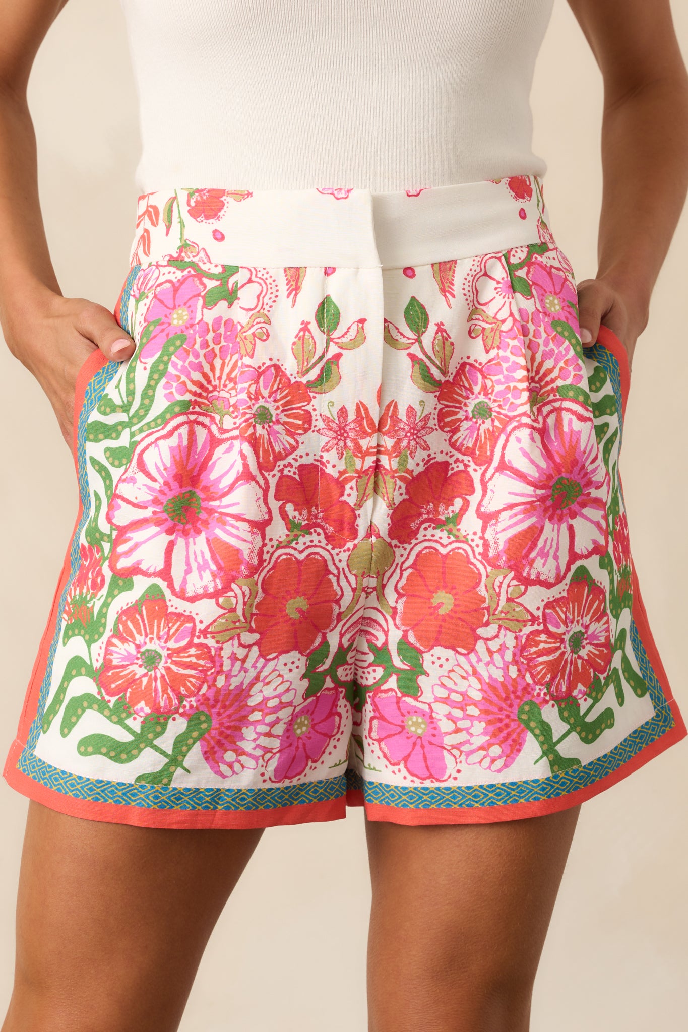 A close-up shot of the floral print fabric, highlighting the texture and intricate pattern of the shorts.